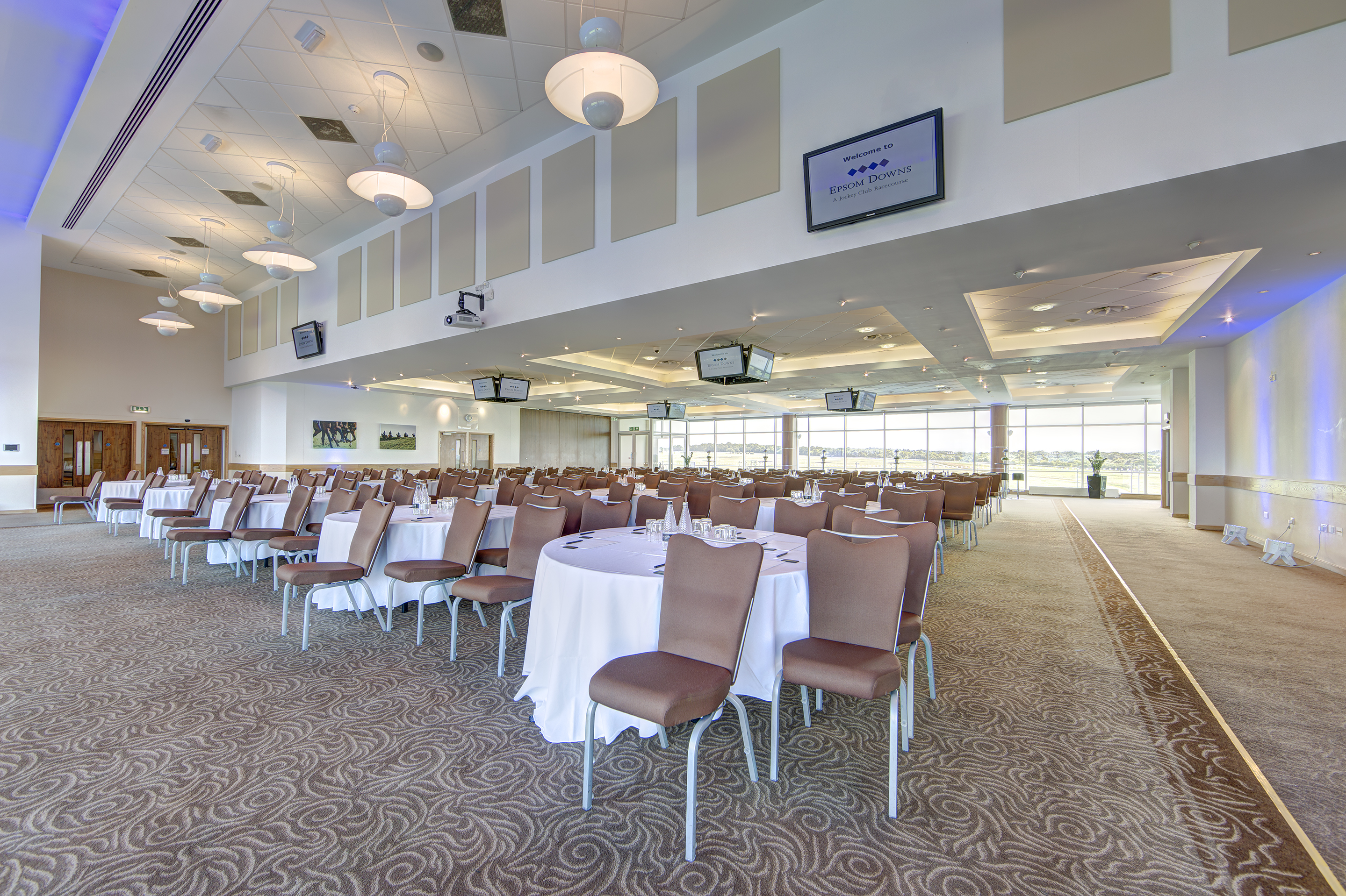 Diomed Suite at Epsom Downs: elegant venue for conferences and banquets with round tables.