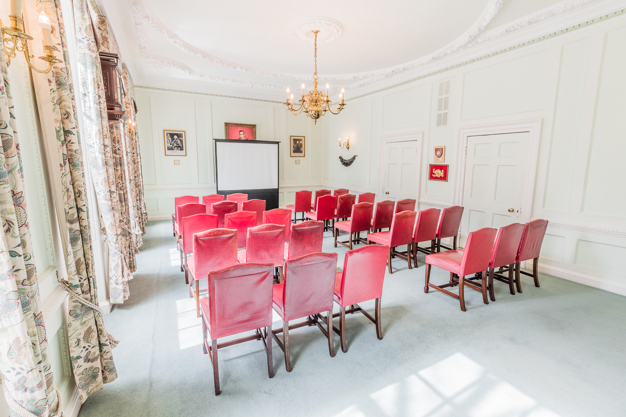 Coopers' Hall meeting room with red chairs, ideal for workshops and presentations.