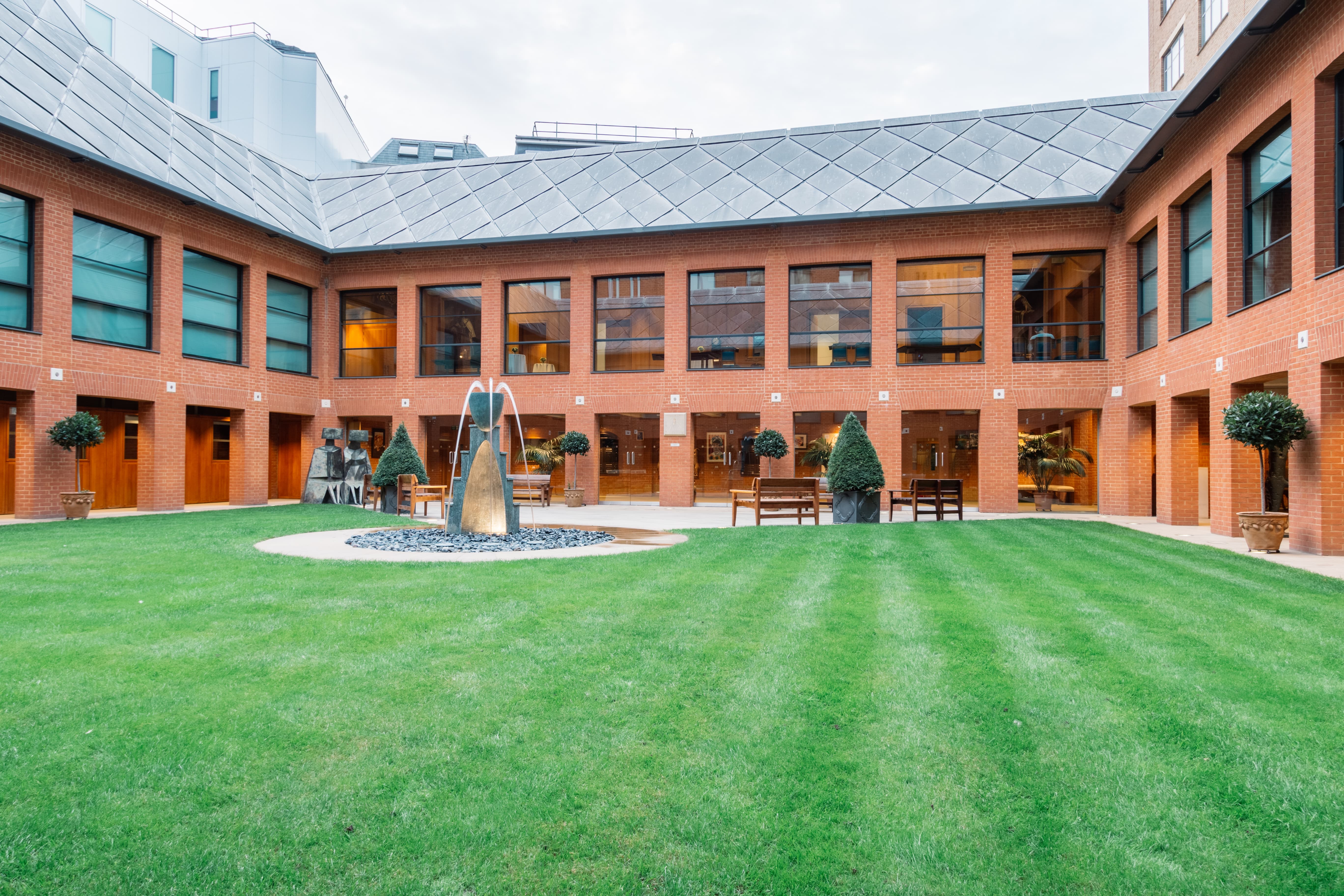 Whole Venue at Haberdashers' Hall courtyard with lush lawn, perfect for outdoor networking events.
