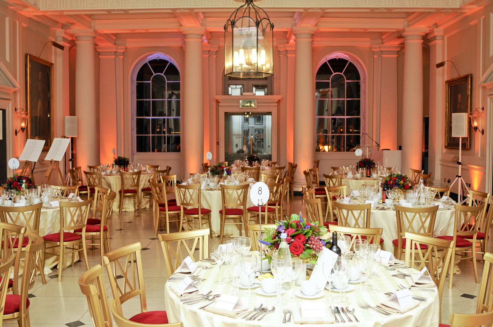 Elegant Seamen's Hall banquet setup with floral centerpieces for formal events.