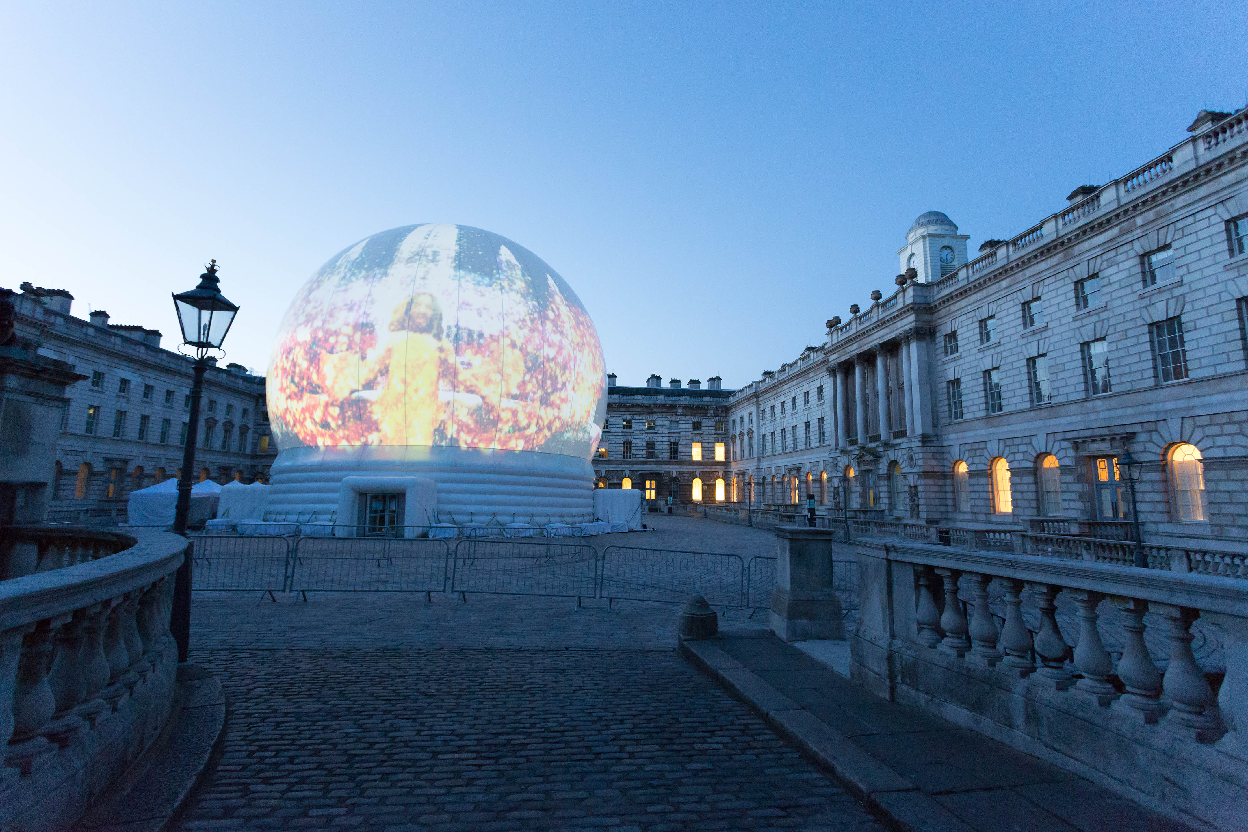 Edmond J. Safra Fountain Court with illuminated dome, ideal for evening receptions and events.