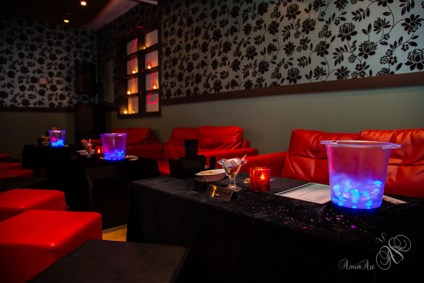 Stylish event venue with red seating, ideal for cocktail receptions or upscale gatherings.