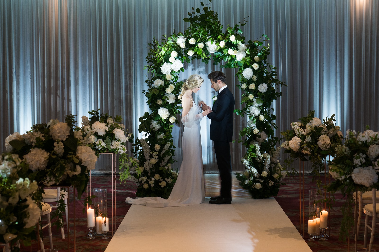 Elegant wedding ceremony setup with floral arch at The Danziger, May Fair Hotel.