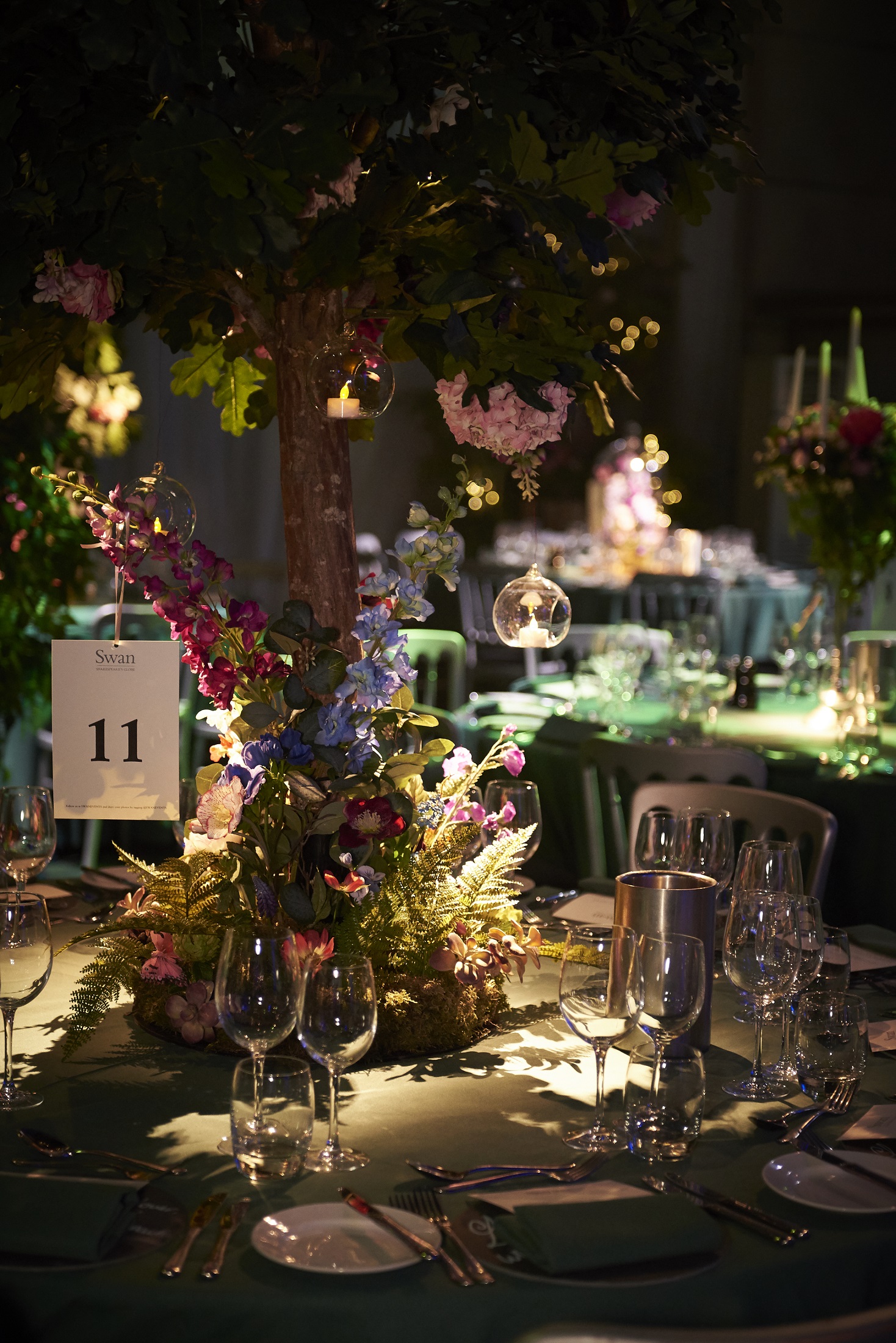 Elegant event space at Underglobe, featuring floral centerpieces and ambient lighting.