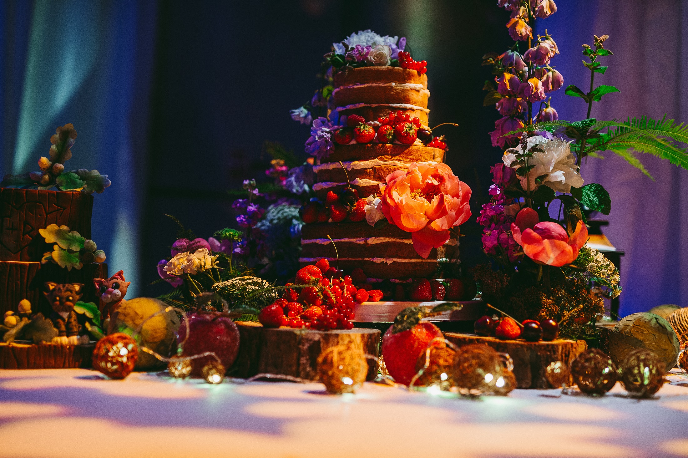 Multi-tiered cake with fresh fruits at Underglobe, perfect for weddings and upscale events.