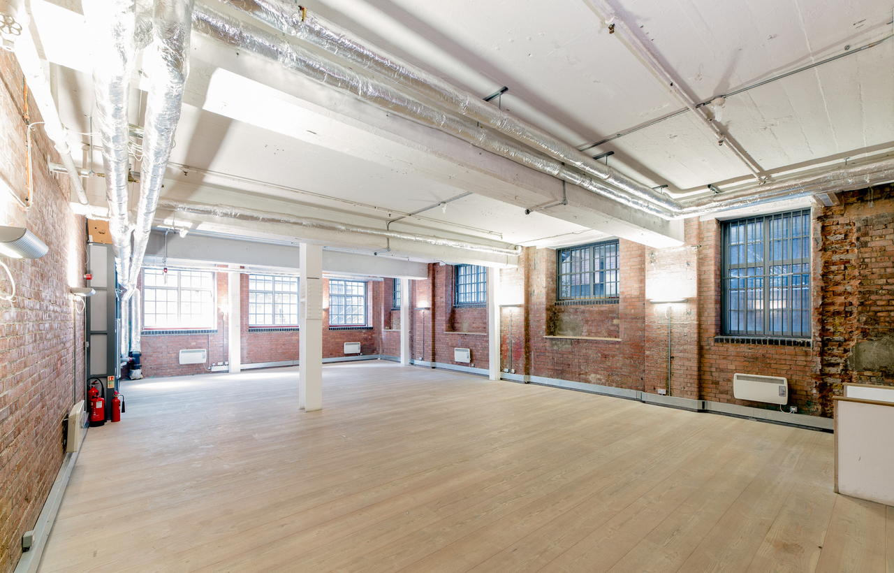 Versatile event space with exposed brick walls in The Vinyl Factory Soho for workshops and networking.