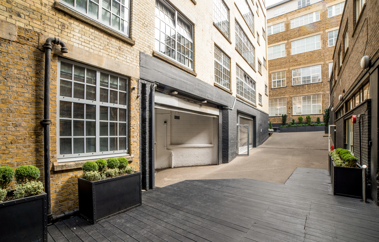 Versatile outdoor event space with industrial brick walls at Rear Studio, The Vinyl Factory.