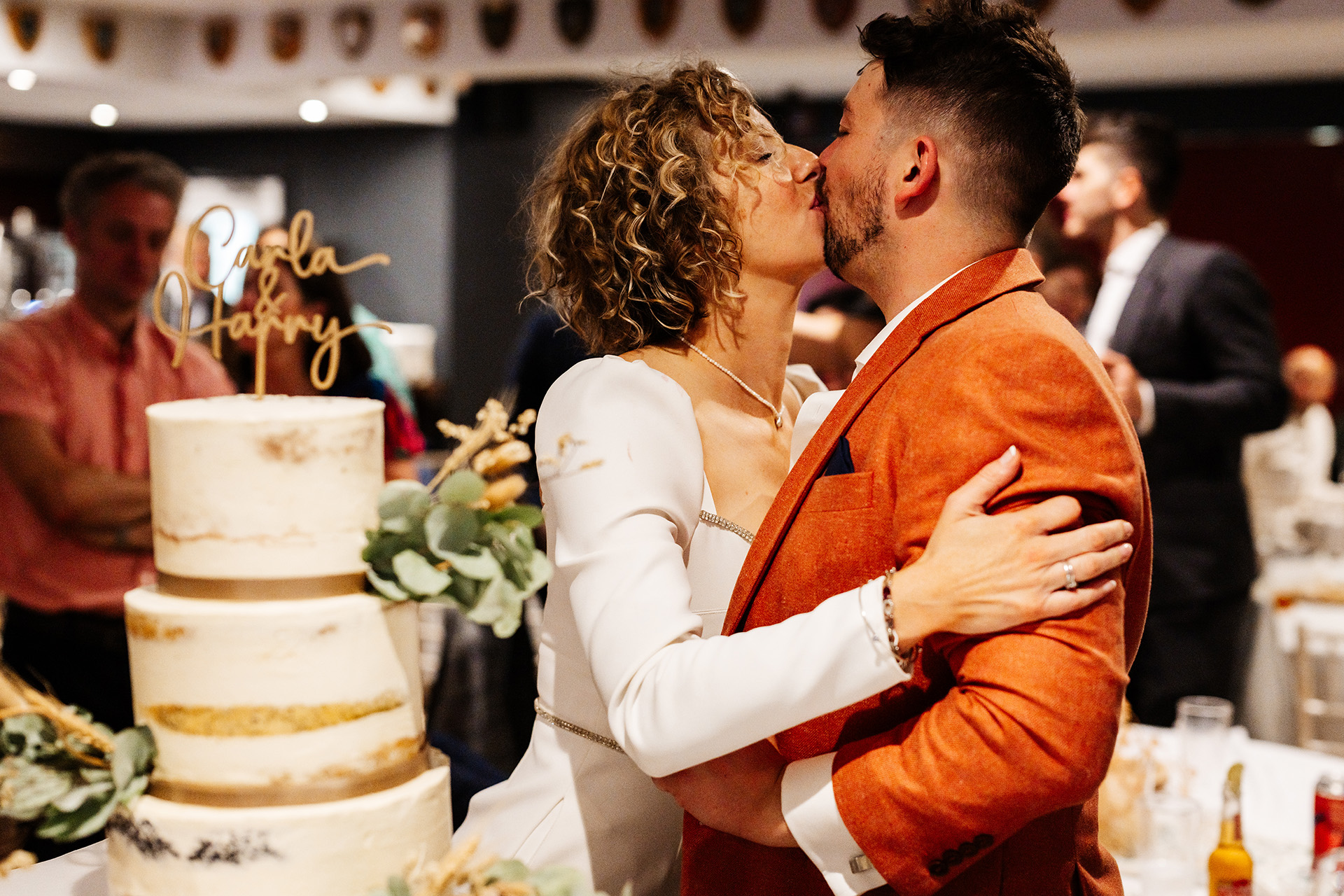 Joyful couple celebrating wedding in elegant Murray Judd Room, Richmond Athletic Ground.