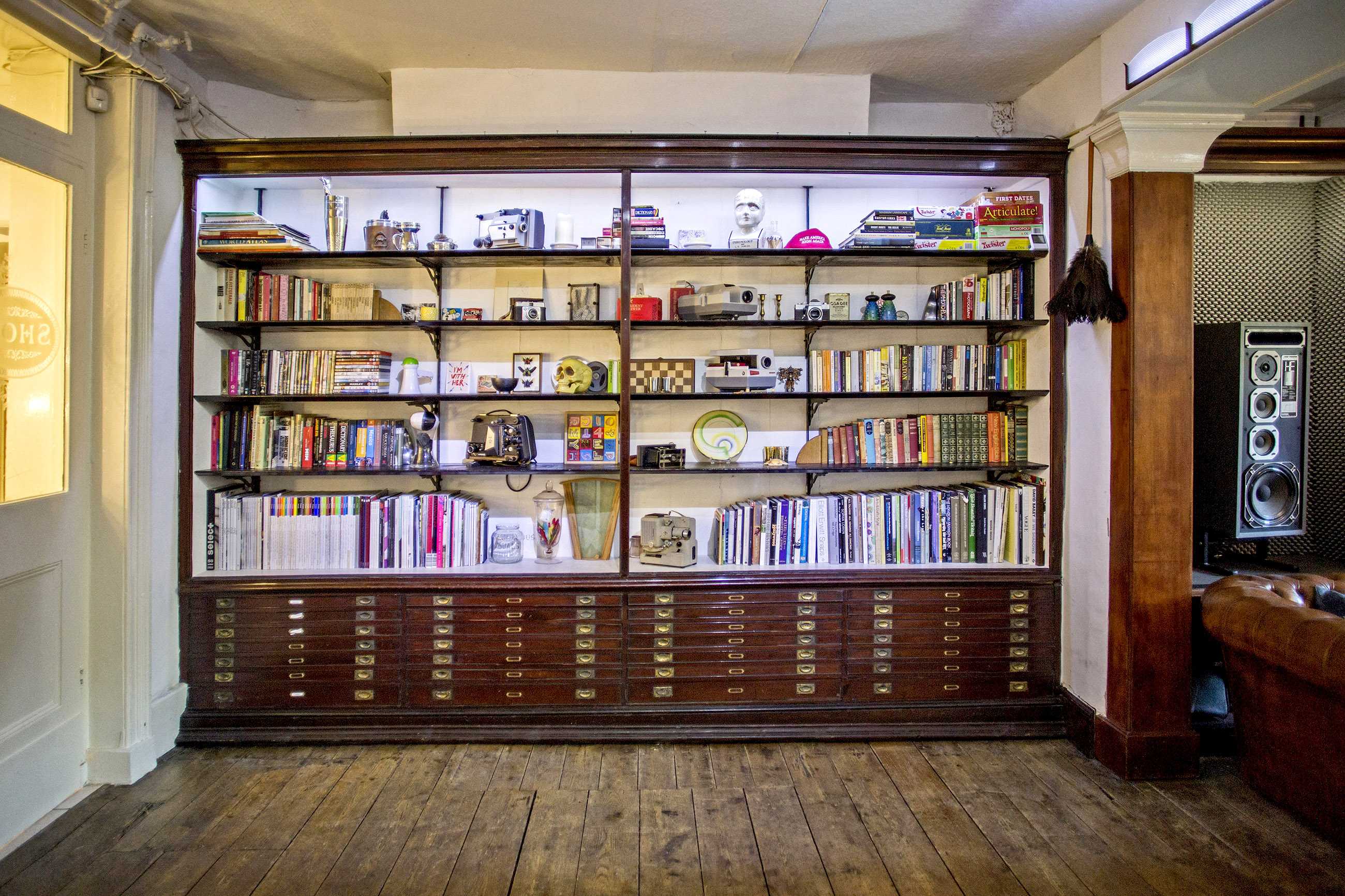 "Organized bookshelf backdrop for creative meetings and events in Anomalous Space."