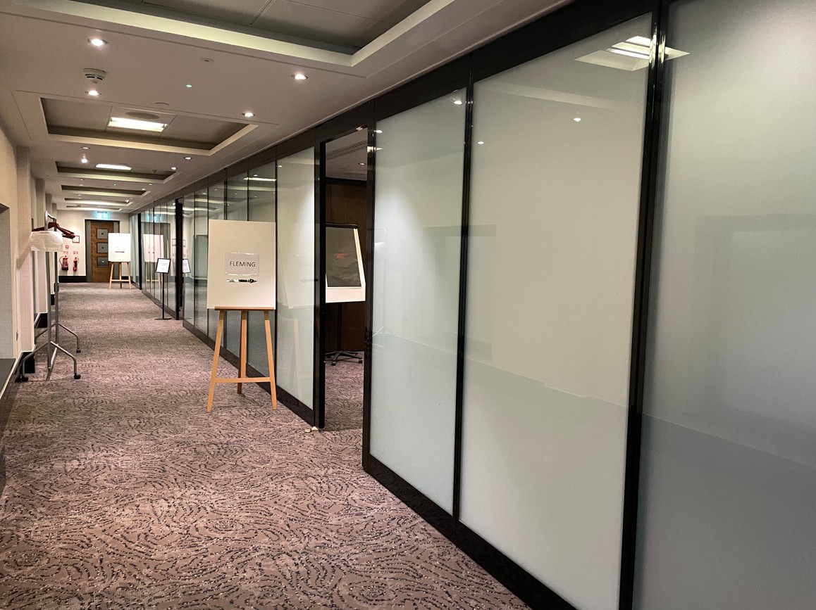 Milton Suite corridor at Leonardo Royal Hotel London - versatile meeting space with frosted glass.