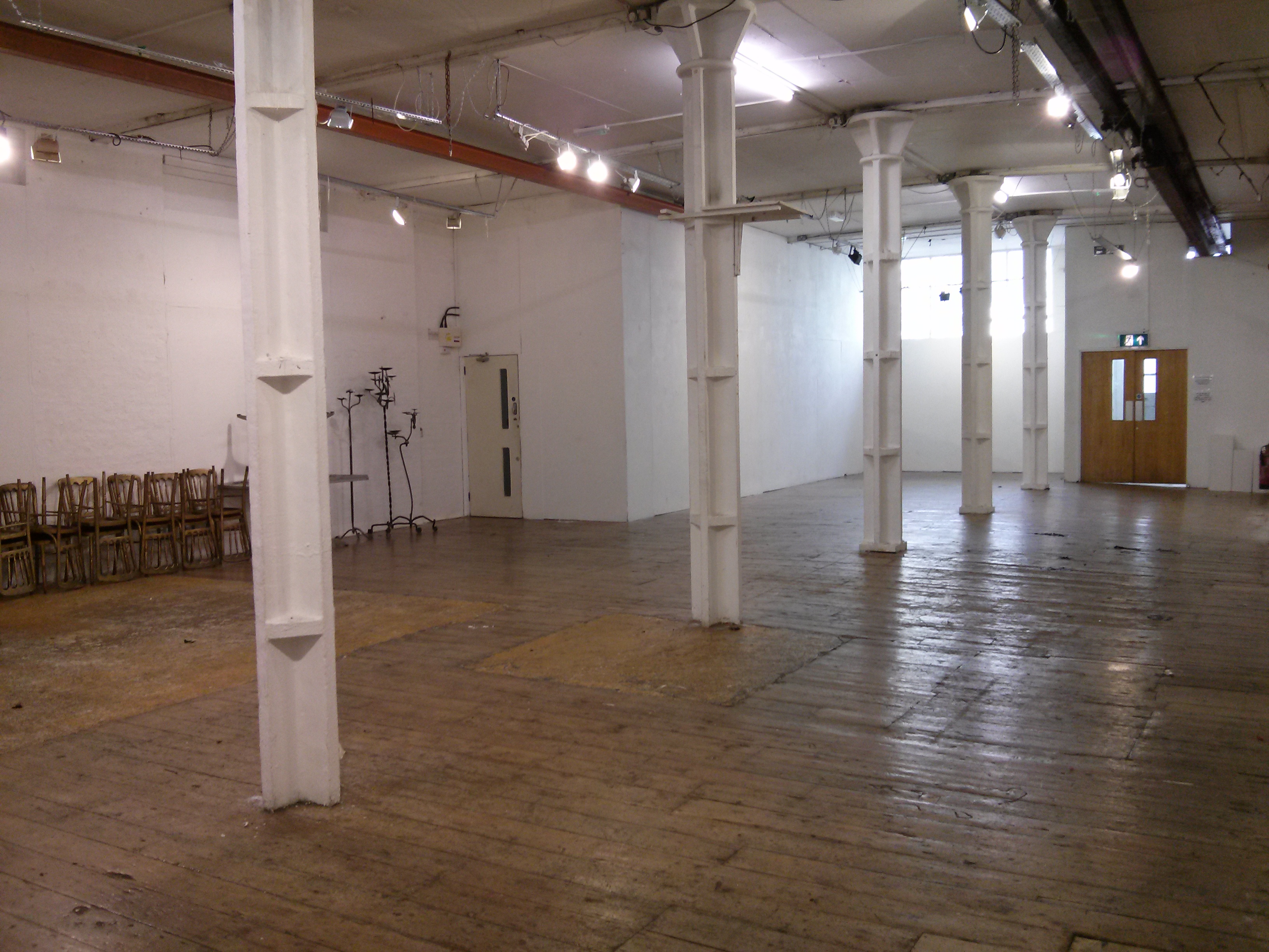 Spacious Ground Floor Gallery venue with wooden floors for versatile events and workshops.