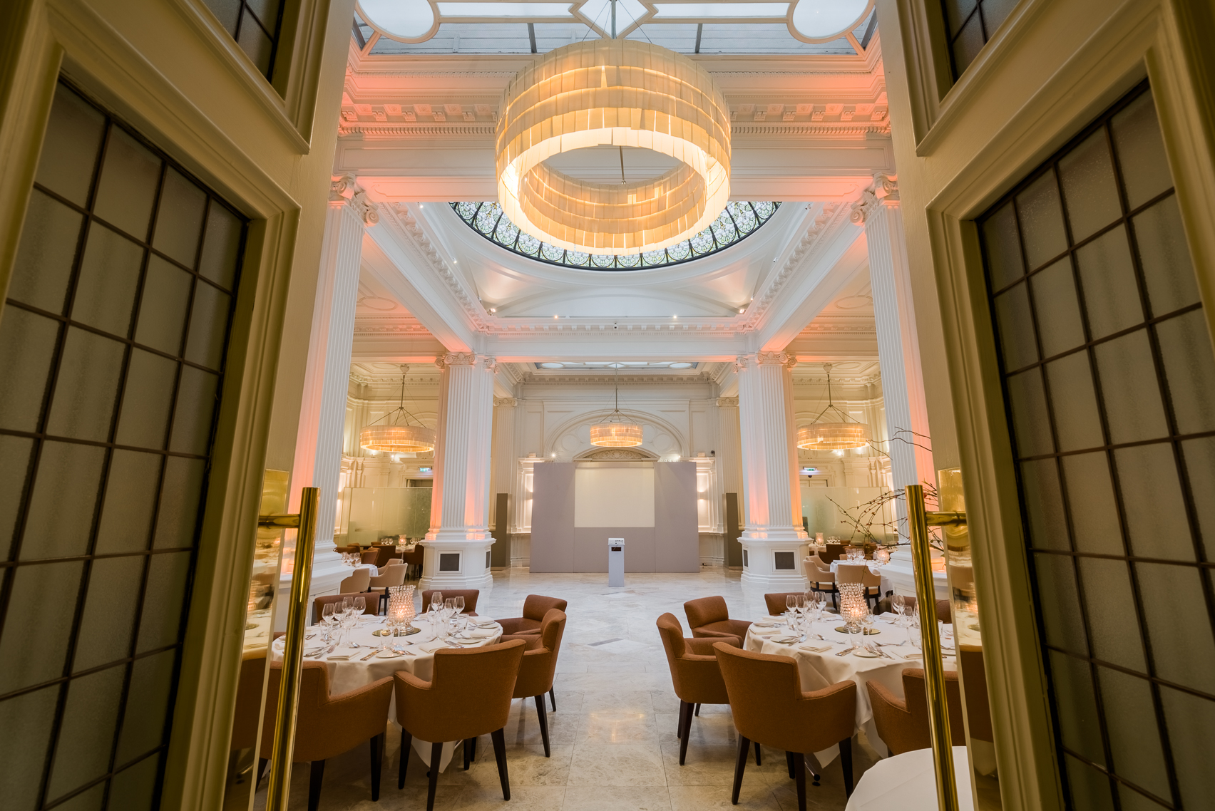 Elegant 1901 Ballroom at Andaz London, ideal for upscale events with stunning chandelier.