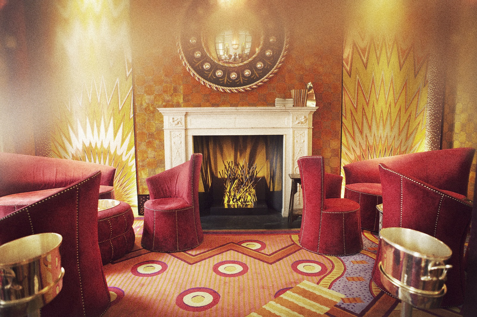 Stylish library meeting space with plush red seating for networking and brainstorming.