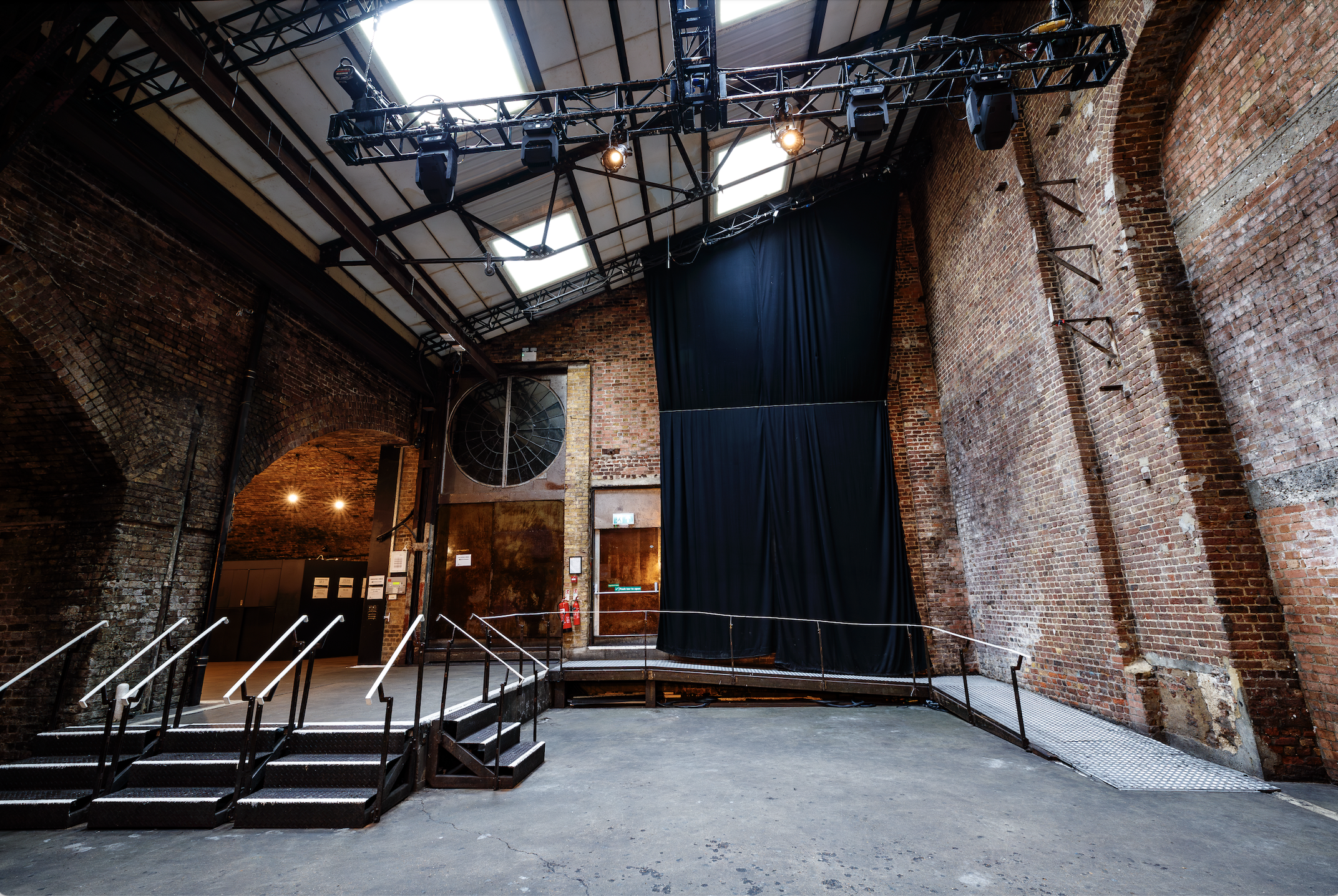 Versatile event space at Village Underground with exposed brick and high ceilings.