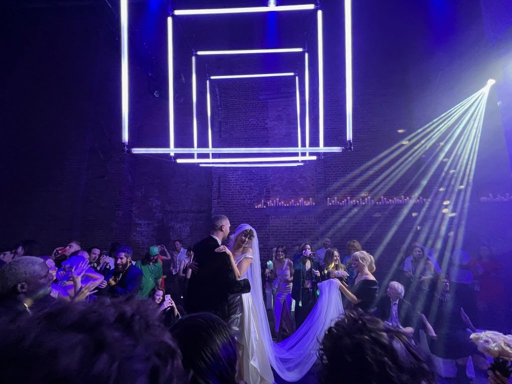 Wedding reception at Village Underground with couple dancing under geometric lighting.