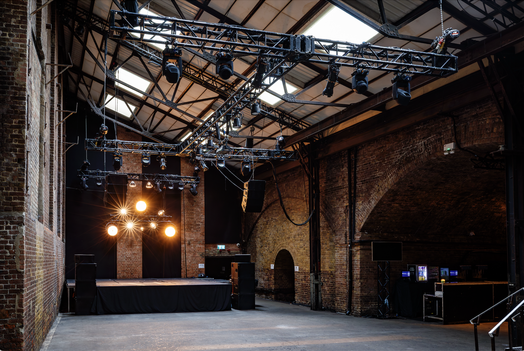 Versatile event space at Village Underground with exposed brick walls, ideal for concerts and workshops.
