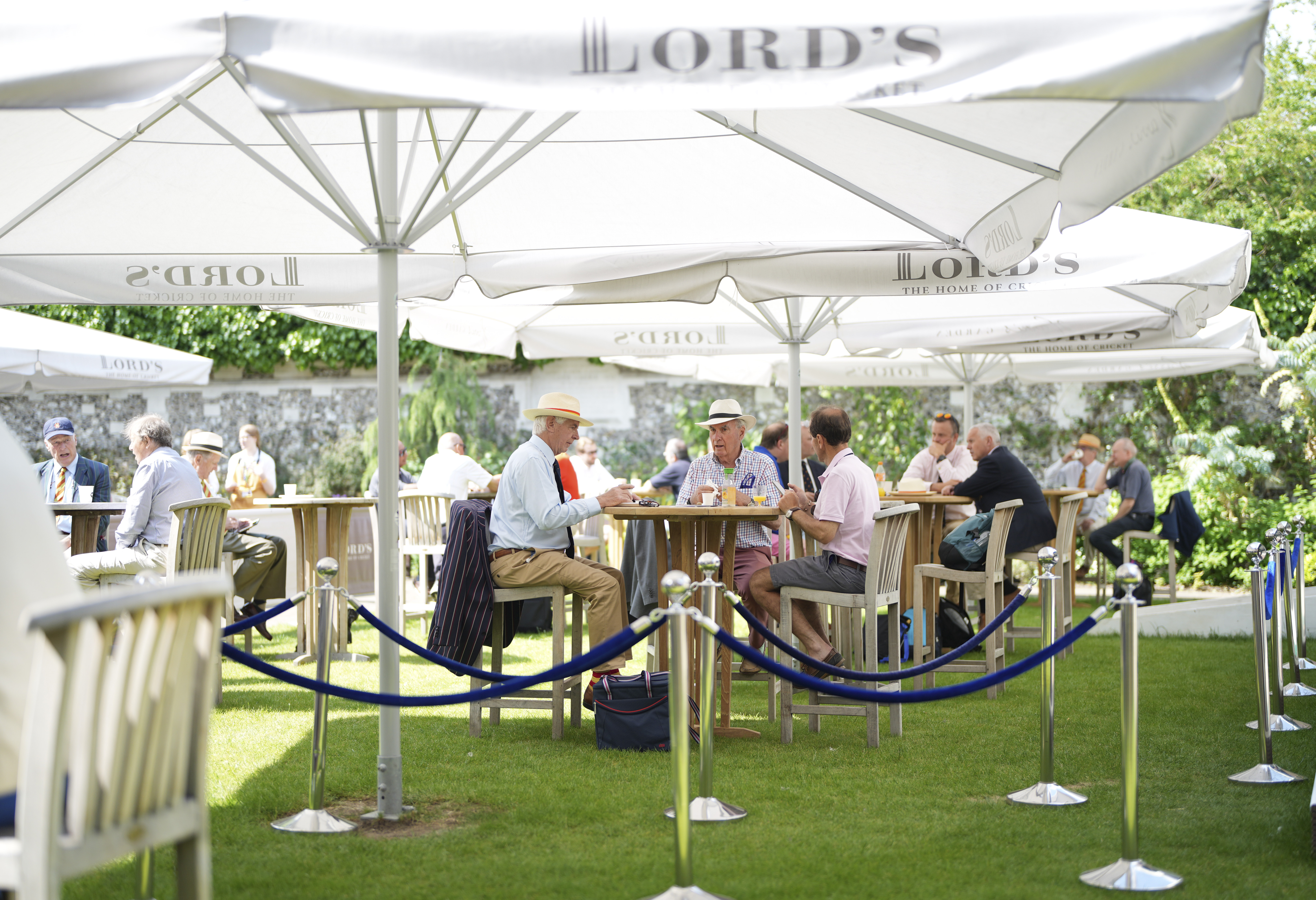 Outdoor networking event at Harris Garden, Lord's Cricket Ground with vibrant greenery.