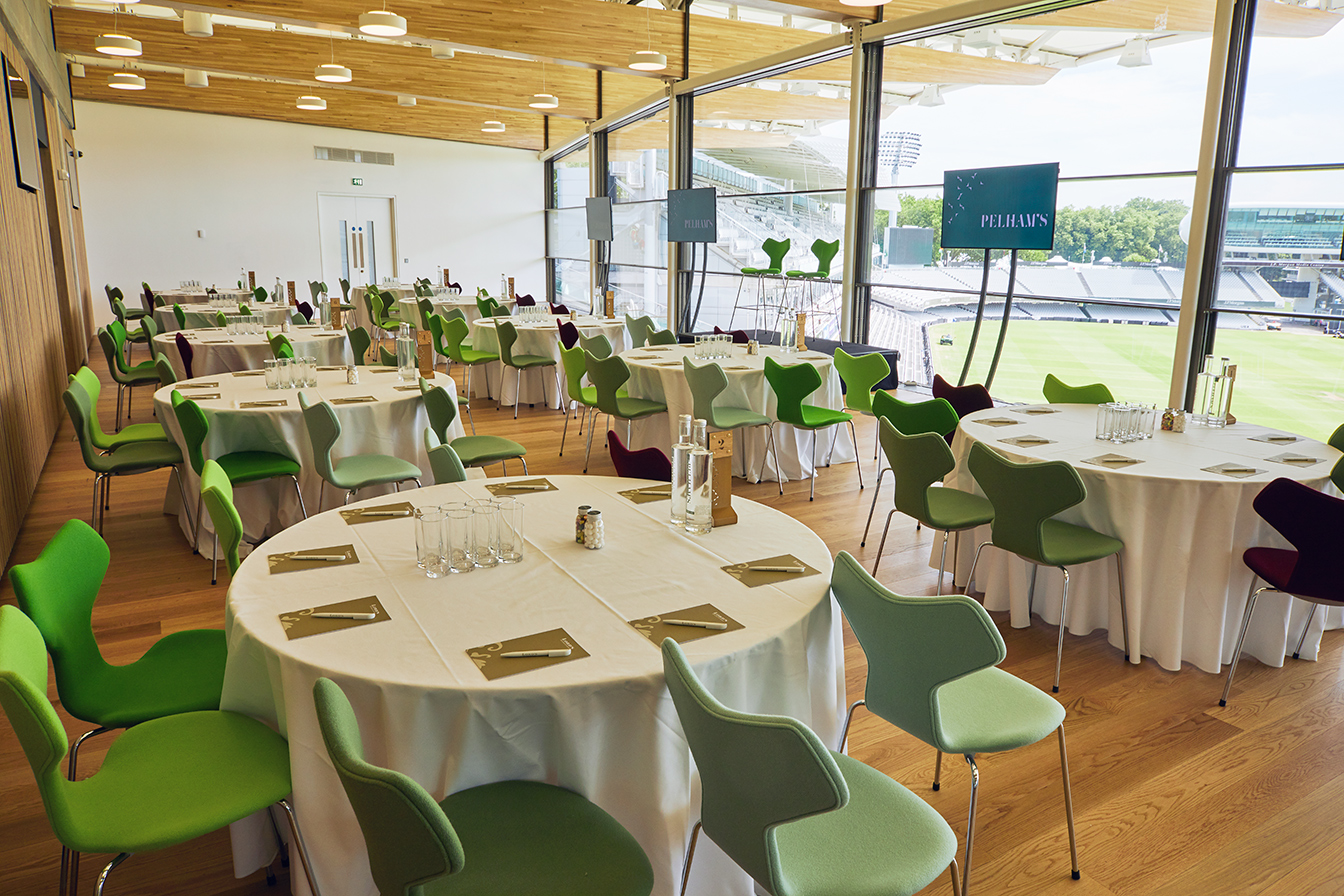 Elegant event space at Lord's Cricket Ground with round tables for corporate meetings.