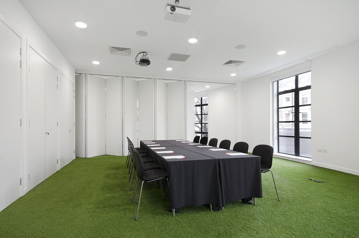 Modern conference room with long table, ideal for presentations and meetings.