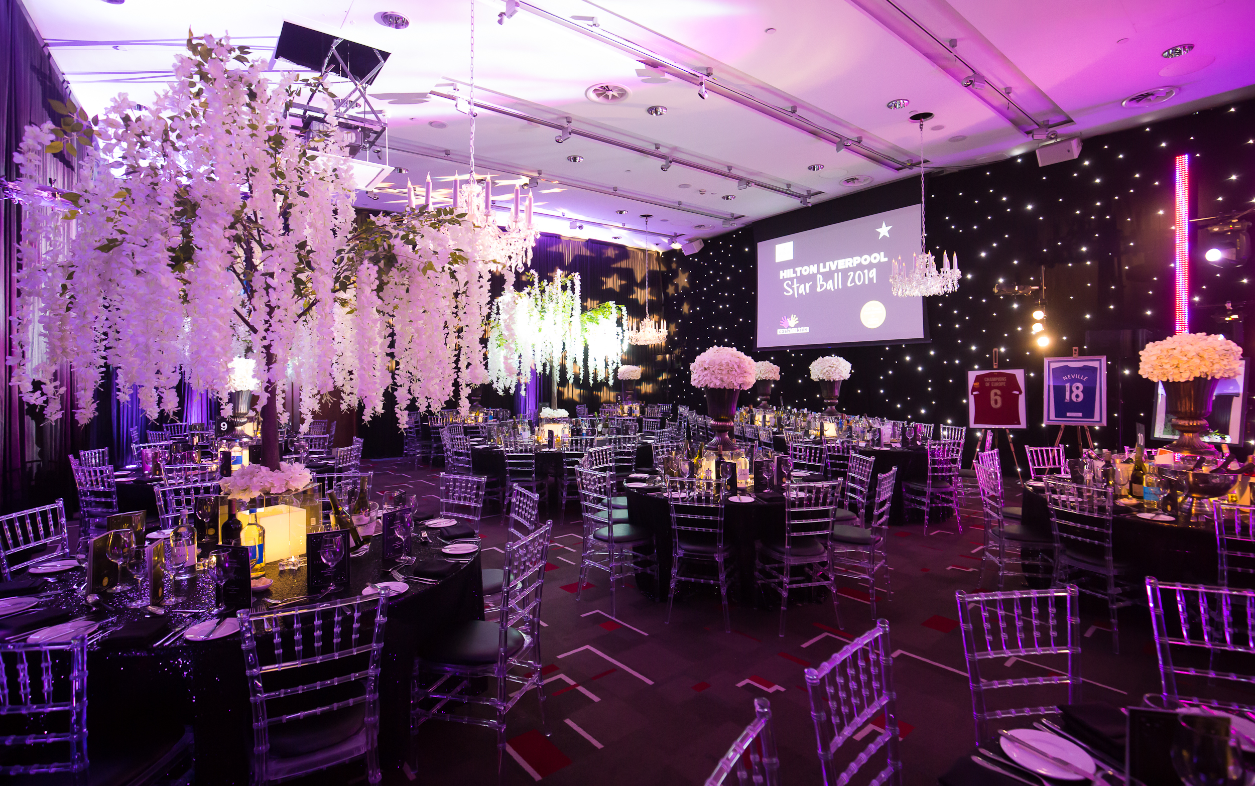Grace Suite at Hilton Liverpool, elegant tables for a gala event with purple lighting.