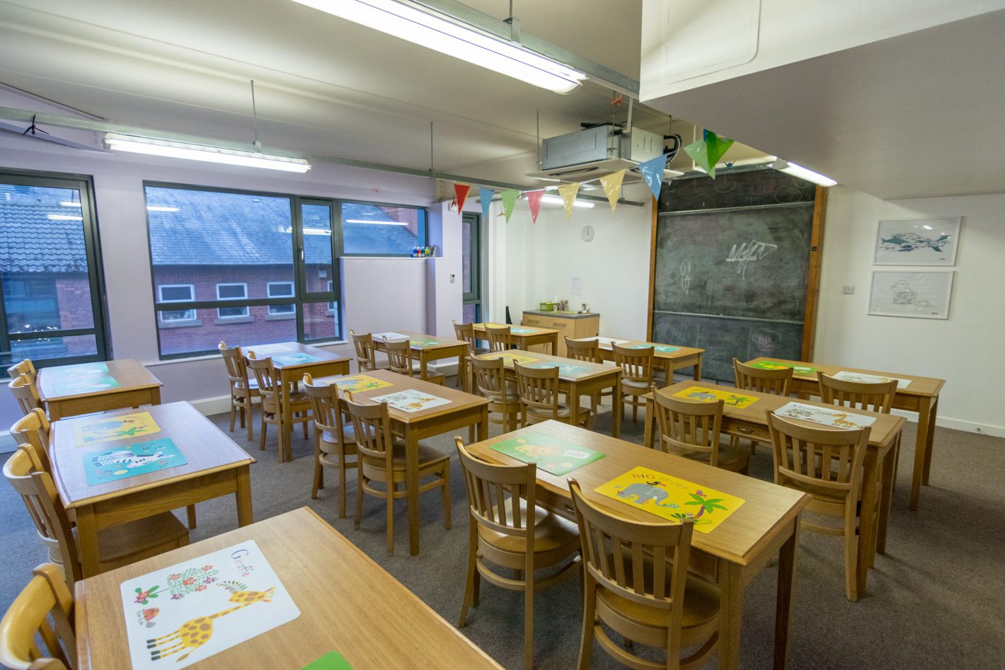 Bright classroom with wooden tables for workshops and training sessions.