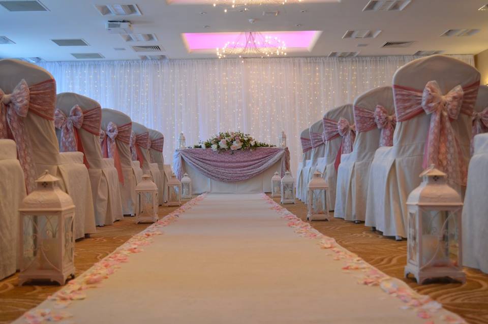 Barton Suite at Barton Grange Hotel, elegant wedding venue with pink sashes and petal aisle.