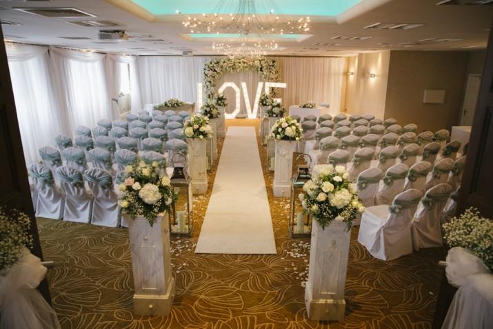 Barton Suite wedding venue with floral decor and "LOVE" sign for romantic ceremonies.
