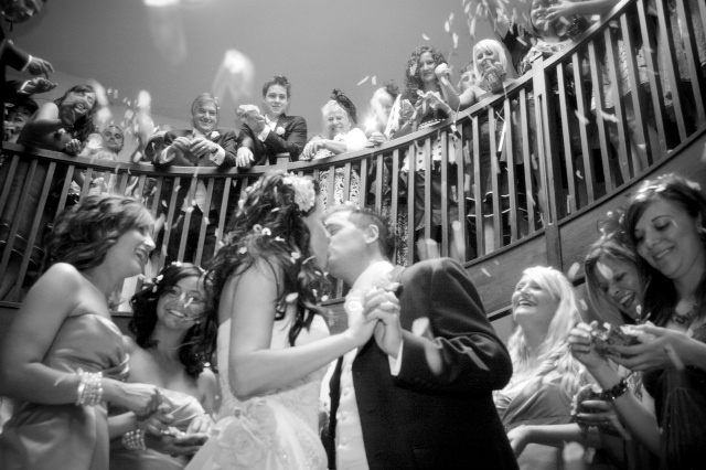Wedding kiss in Barton Suite, black and white elegance, guest engagement celebration.