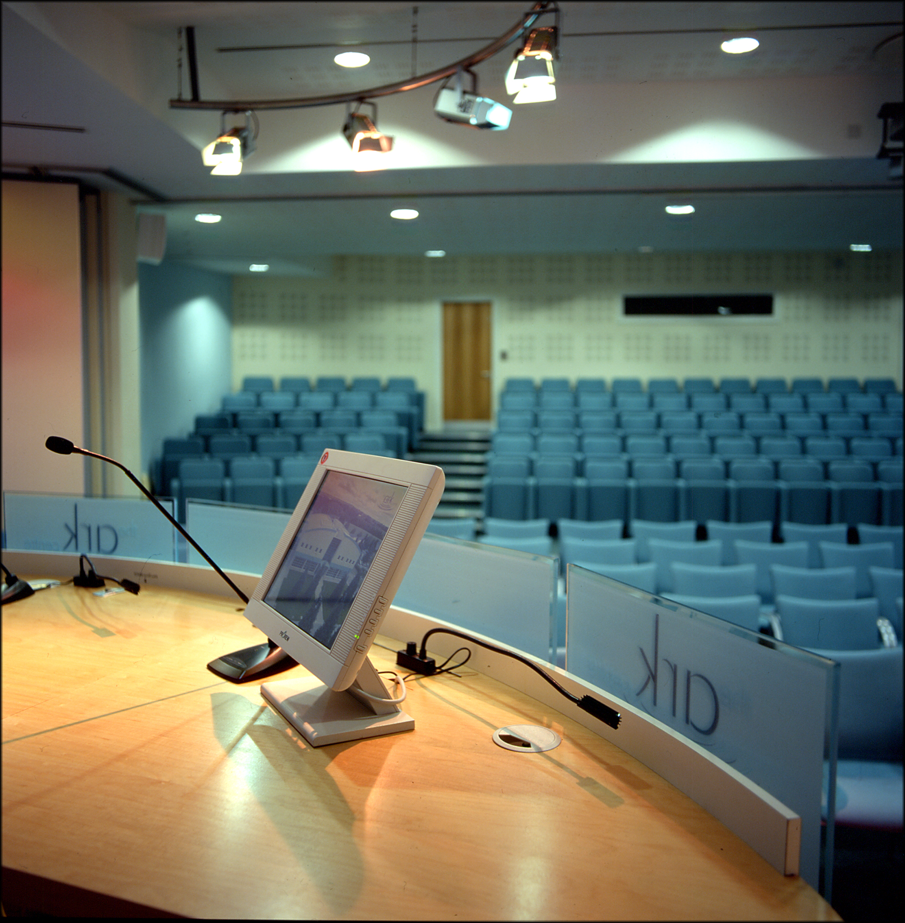 Squire Theatre conference room with podium, ideal for presentations and events.