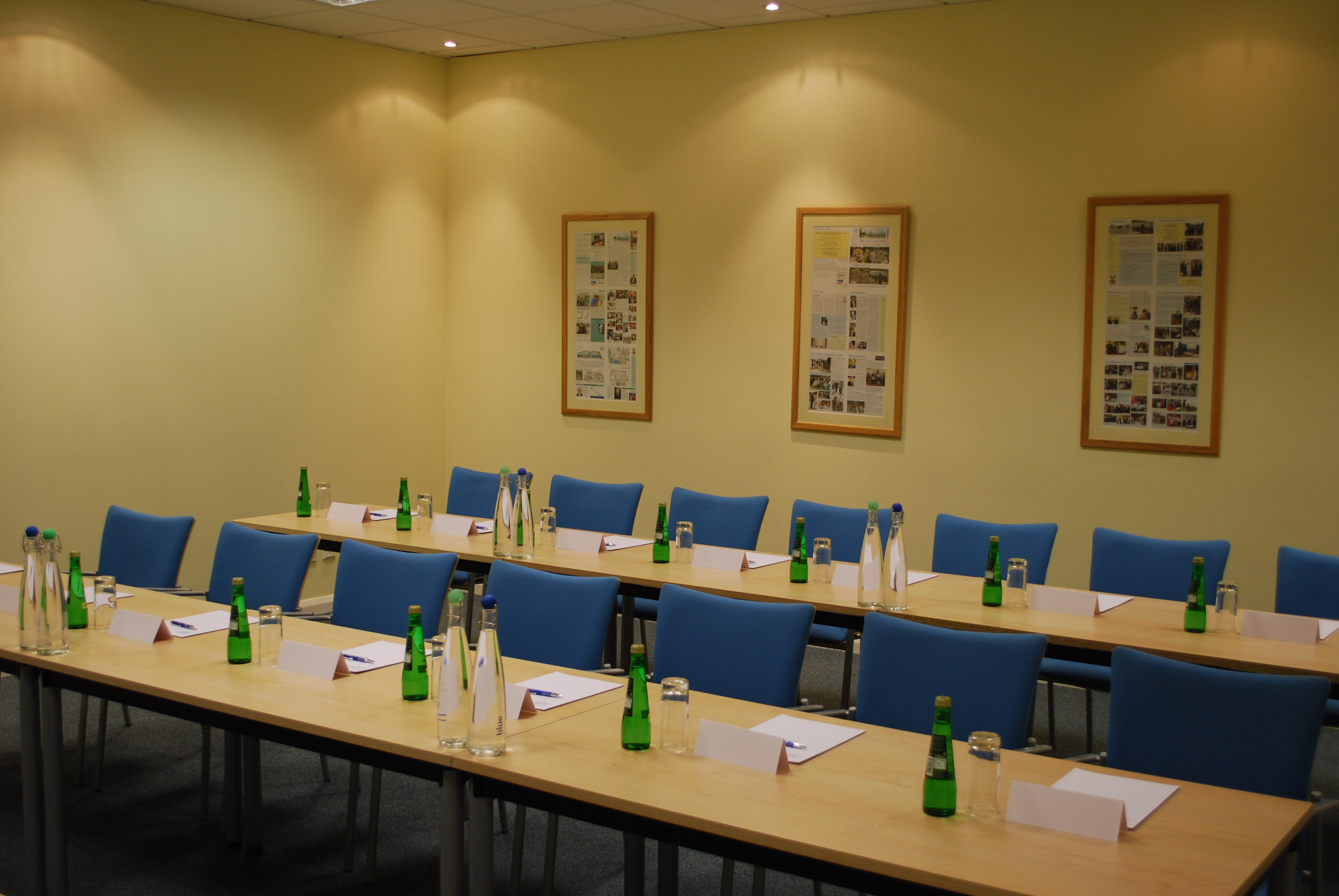 Meeting room at The Ark Conference Centre with blue chairs, ideal for conferences and workshops.