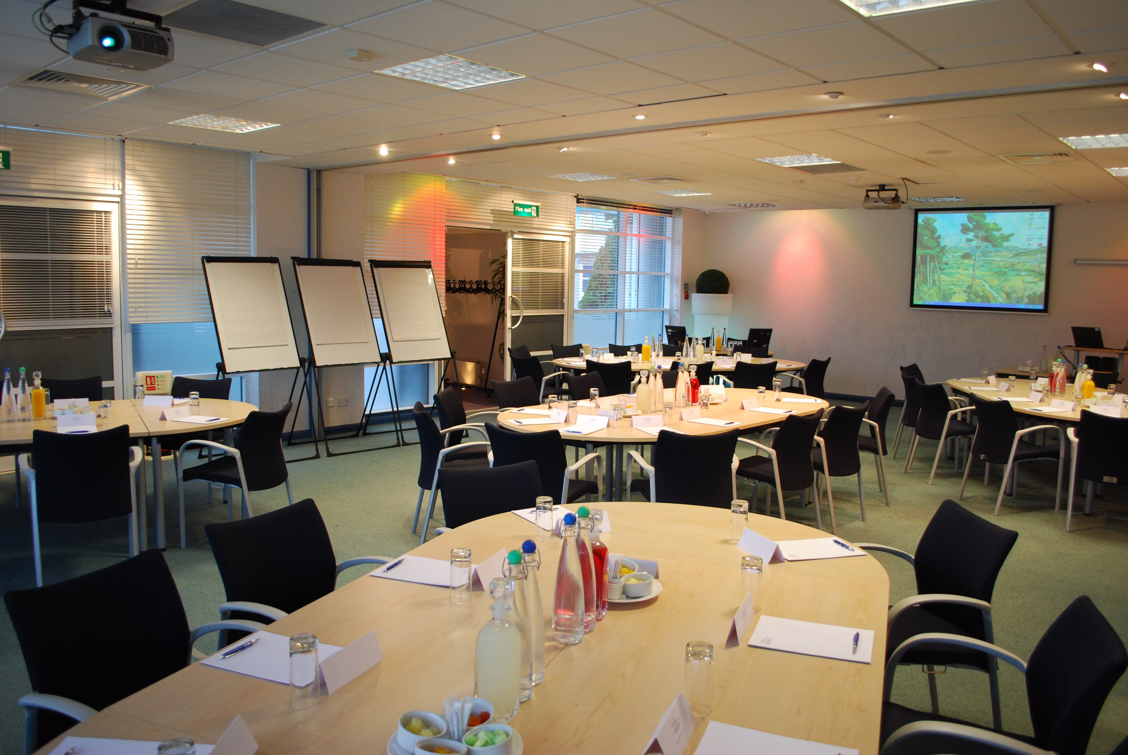 Caspian/Andaman meeting space with round tables for workshops and collaboration.