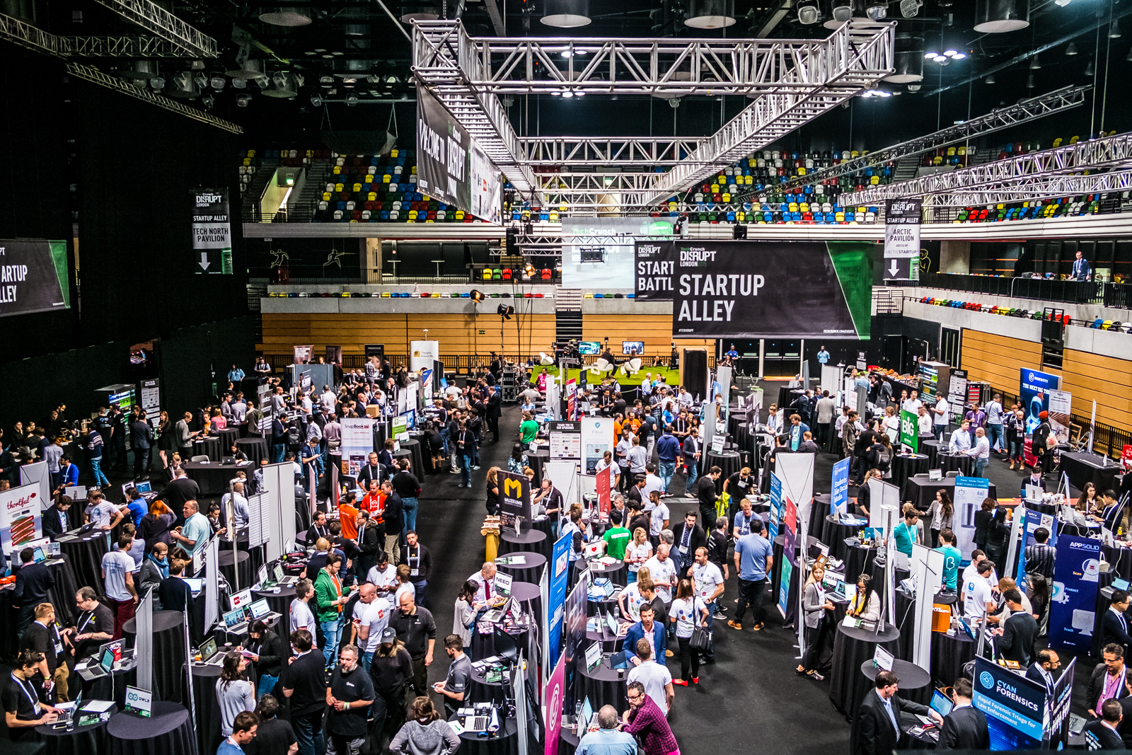 Copper Box Arena trade show with bustling attendees and high ceiling booths.