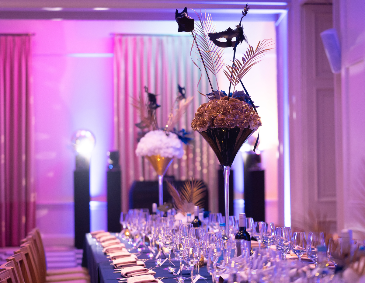 Elegant Christmas party setup with purple lighting and glamorous centerpieces in Kent House.