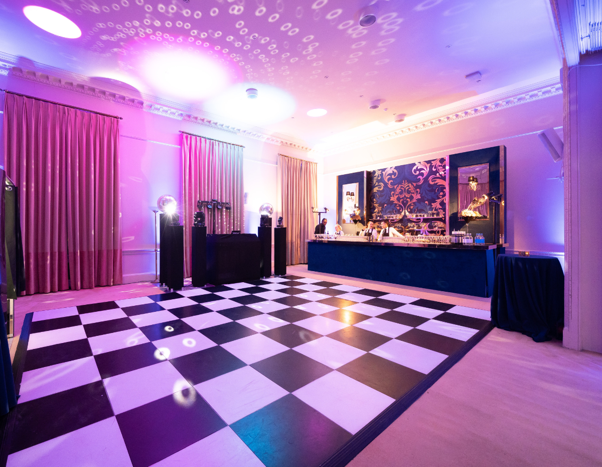 "Elegant Christmas party venue in Kent House with checkered dance floor and vibrant lighting."