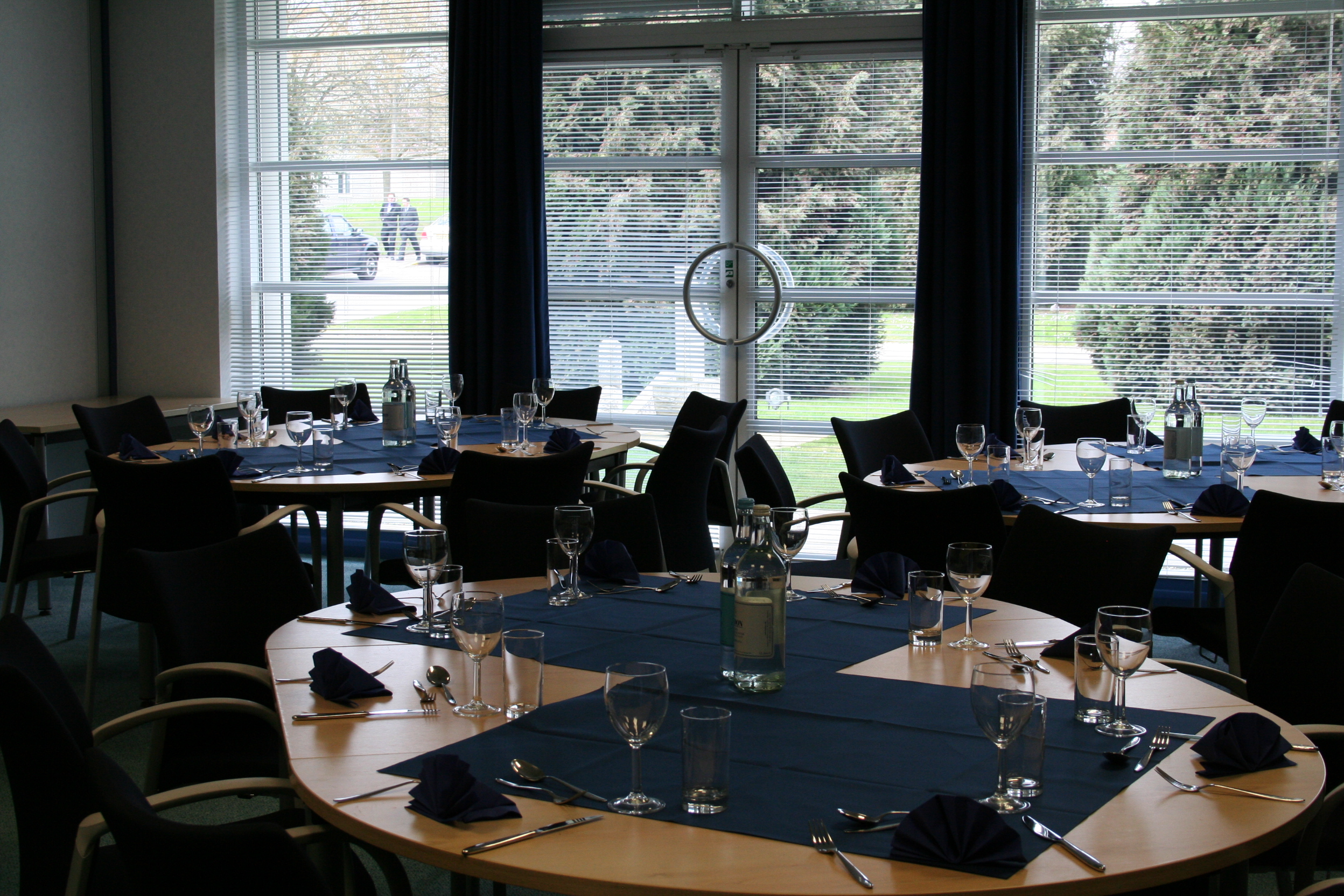 Caspian event space with navy blue tables, ideal for meetings and conferences.