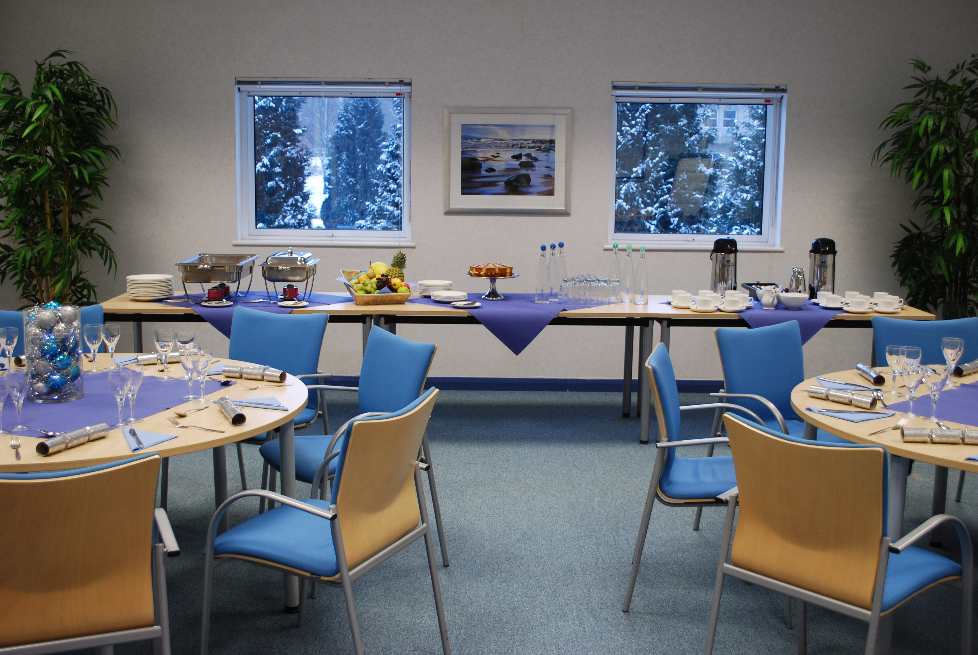 Lugano conference room with round tables, ideal for networking events and meetings.