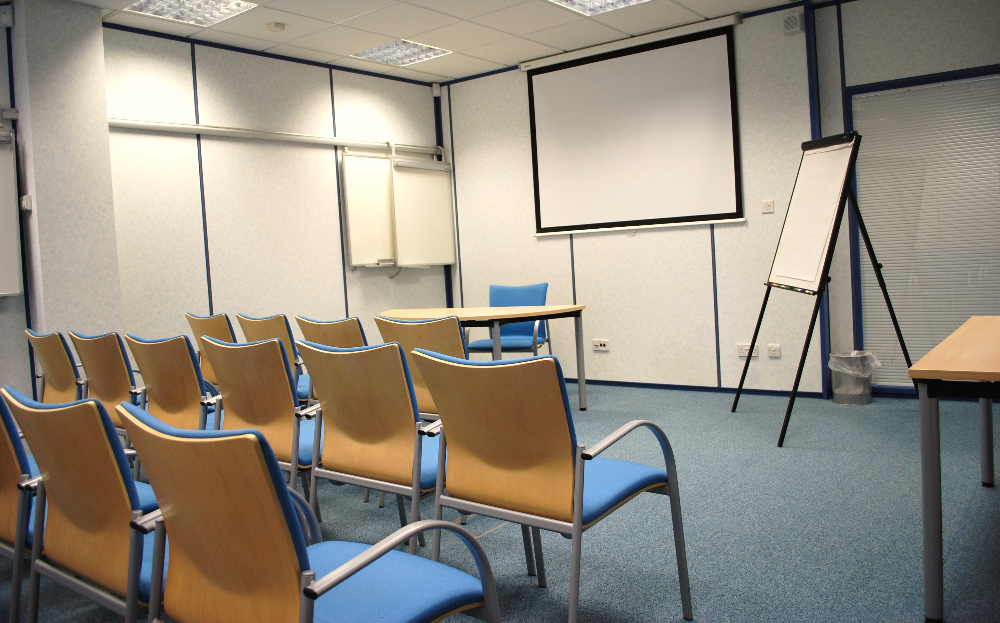 Meeting room at The Ark Conference Centre with blue chairs, ideal for workshops and presentations.
