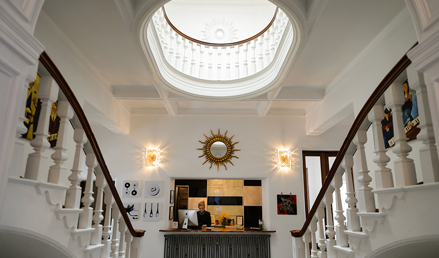 Elegant Leverhulme Hotel Conservatory lobby with grand staircase, perfect for events.