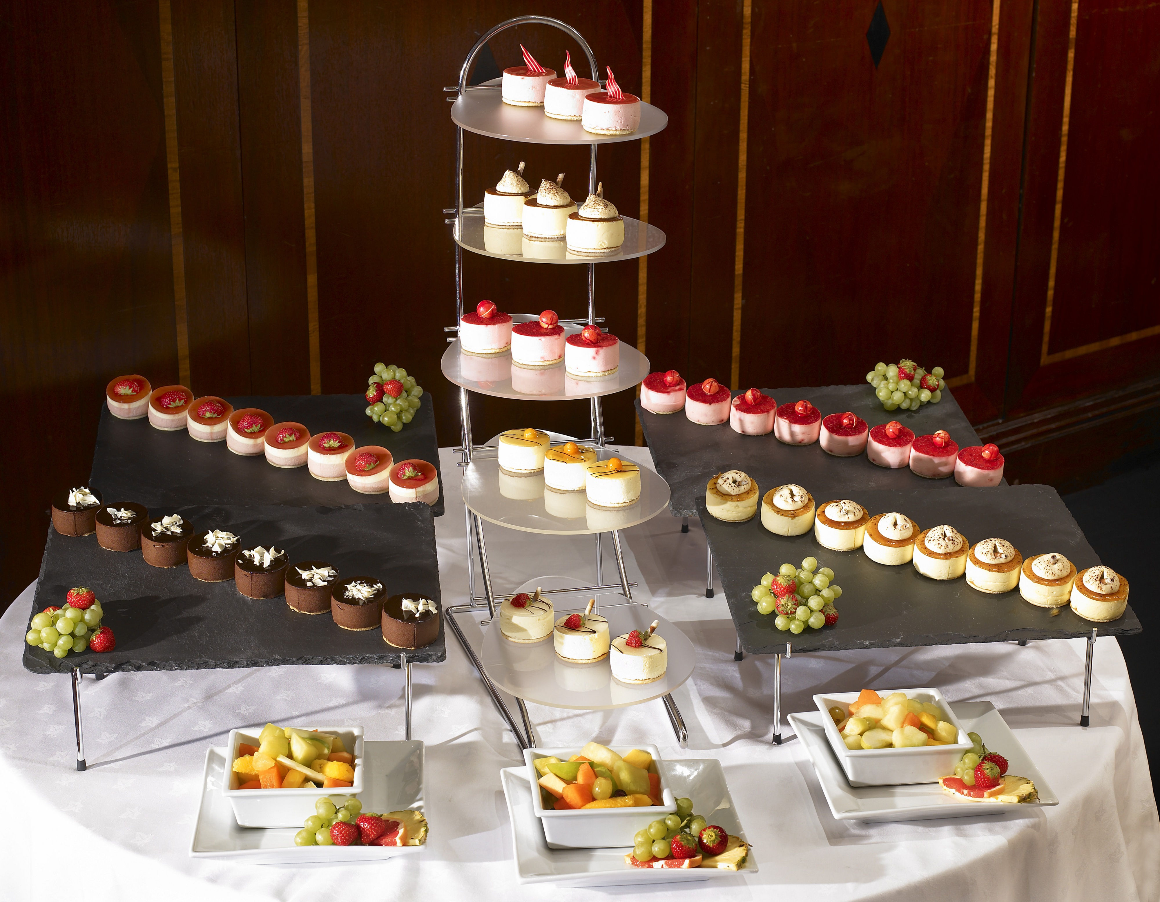 Elegant dessert display with mini cakes at Trevelyan Suite, Leeds Marriott Hotel event.
