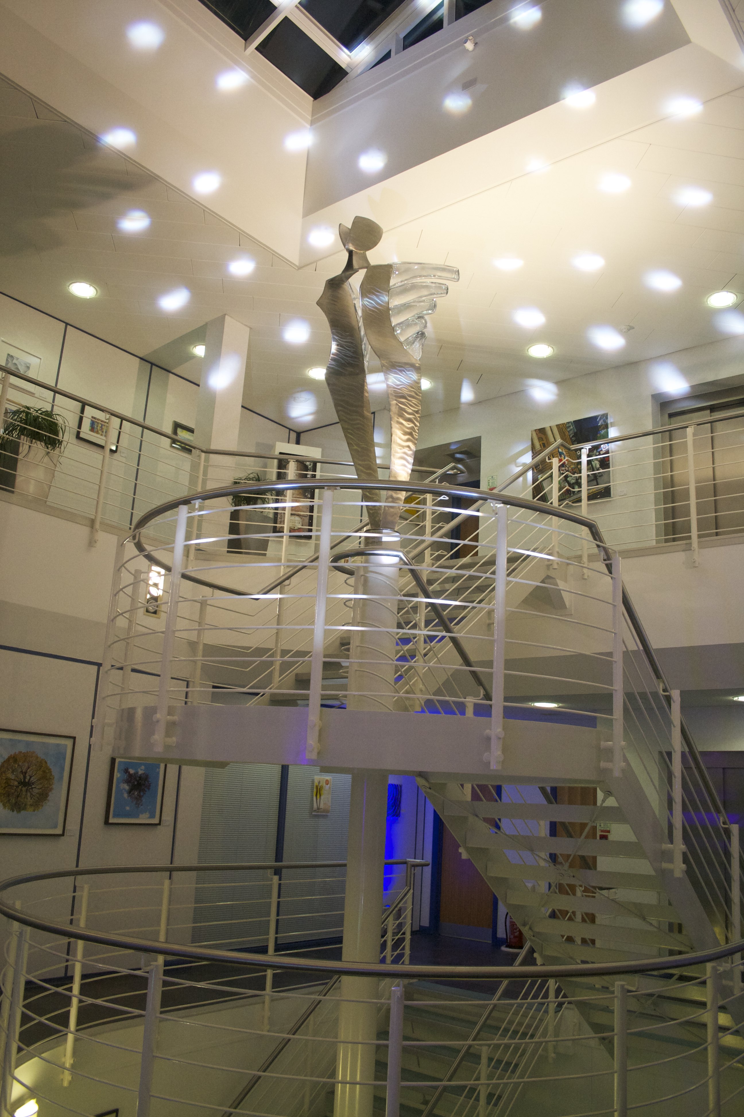 Modern atrium venue with sleek railings, ideal for networking events and receptions.