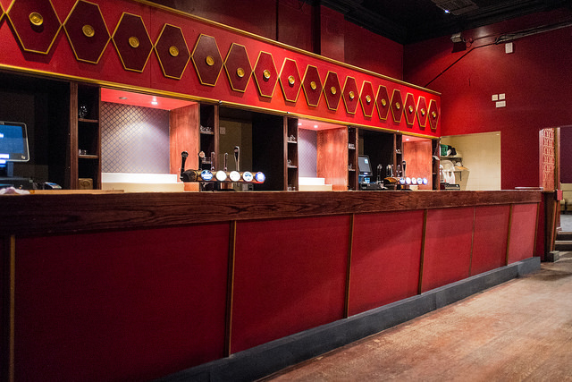 The Arcade bar at The Four Thieves, featuring a red and gold color scheme for events.