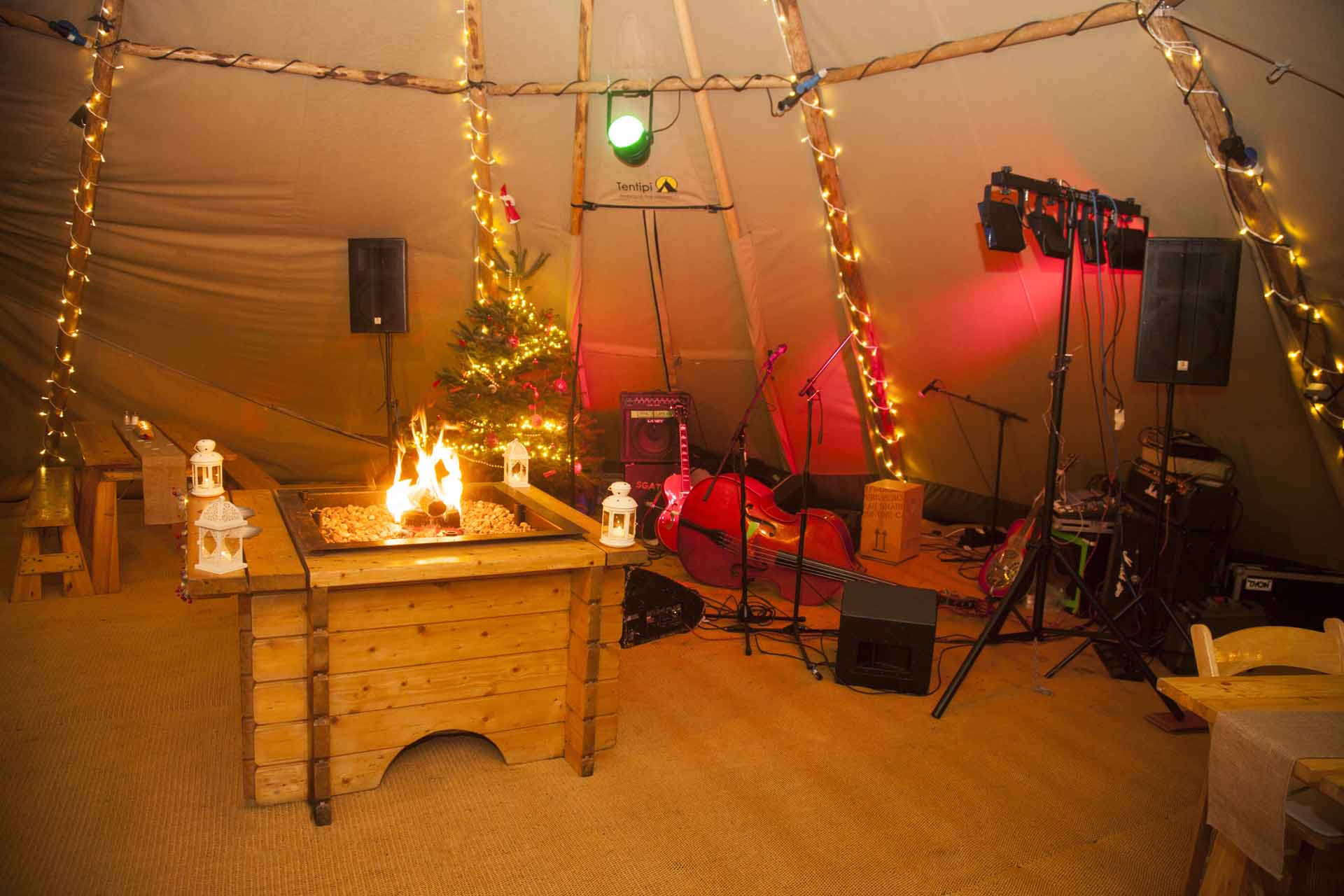 Cozy Forest Tepee venue with warm lighting for winter events and intimate gatherings.