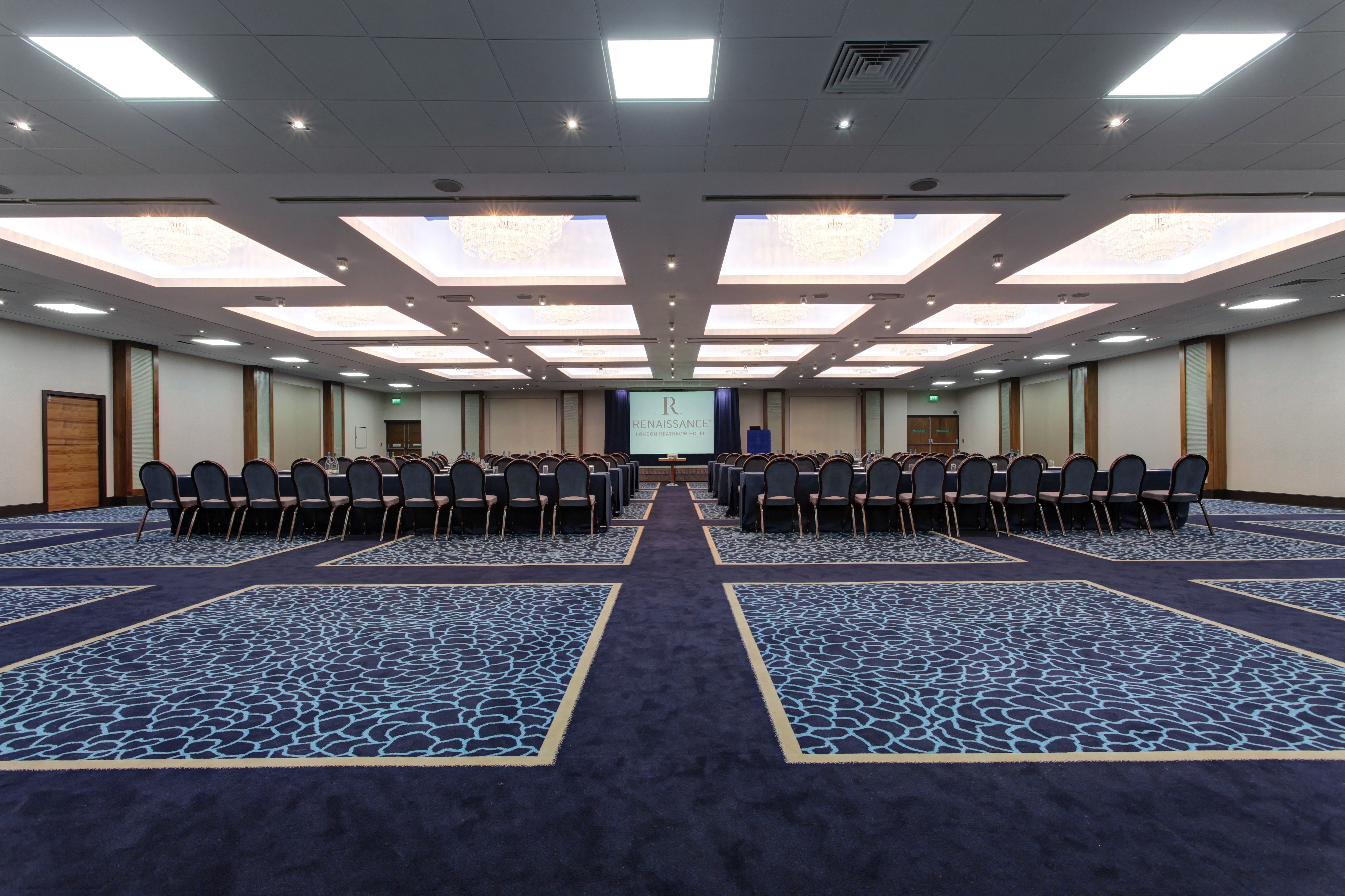 Wessex Ballroom conference setup with U-shaped seating and modern lighting at Heathrow Hotel.