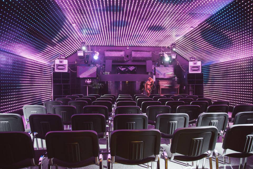 Modern event space Lightbox in Vauxhall Arches with vibrant LED backdrop for dynamic presentations.