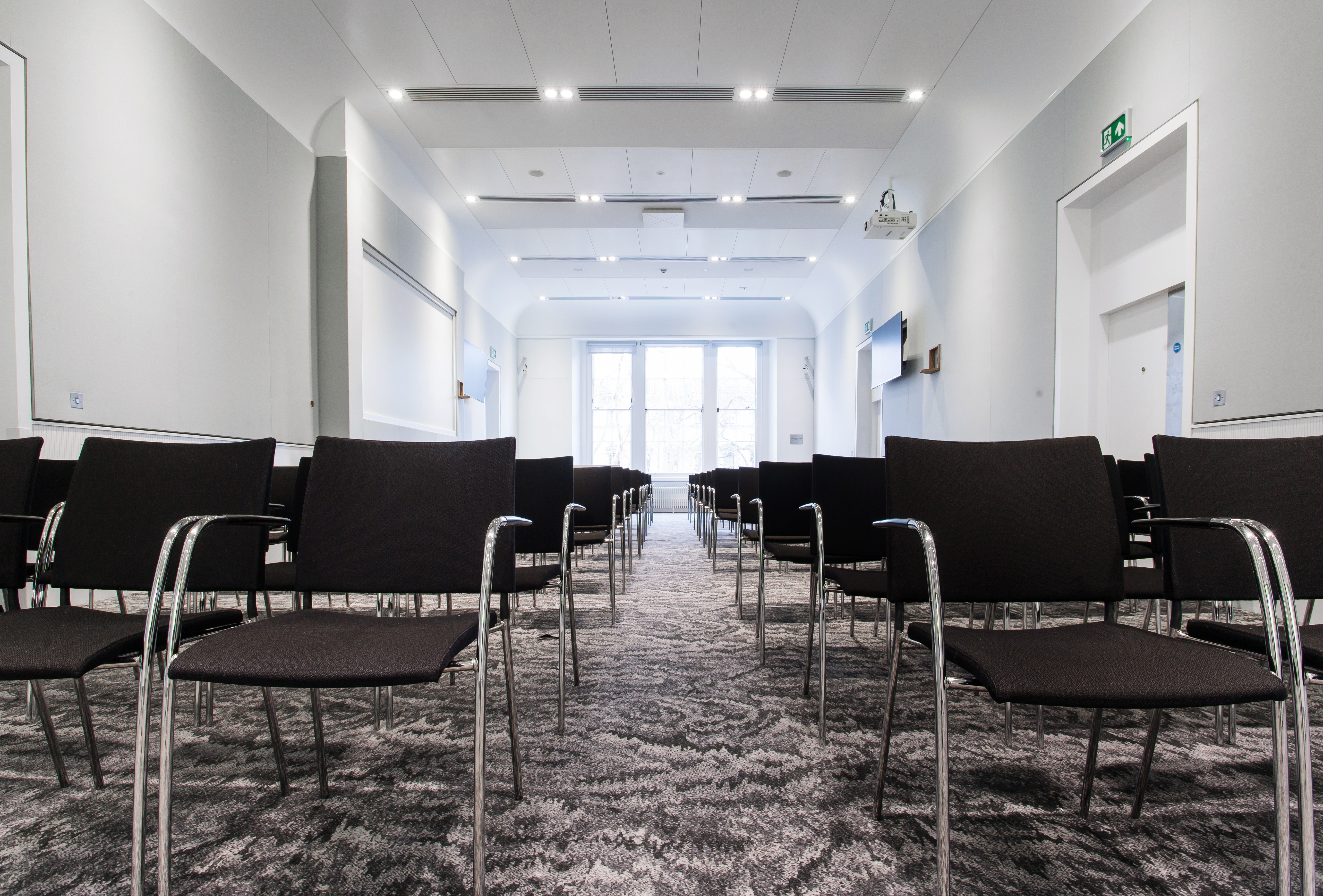 Al Qasimi meeting room with sleek black chairs, ideal for presentations and workshops.