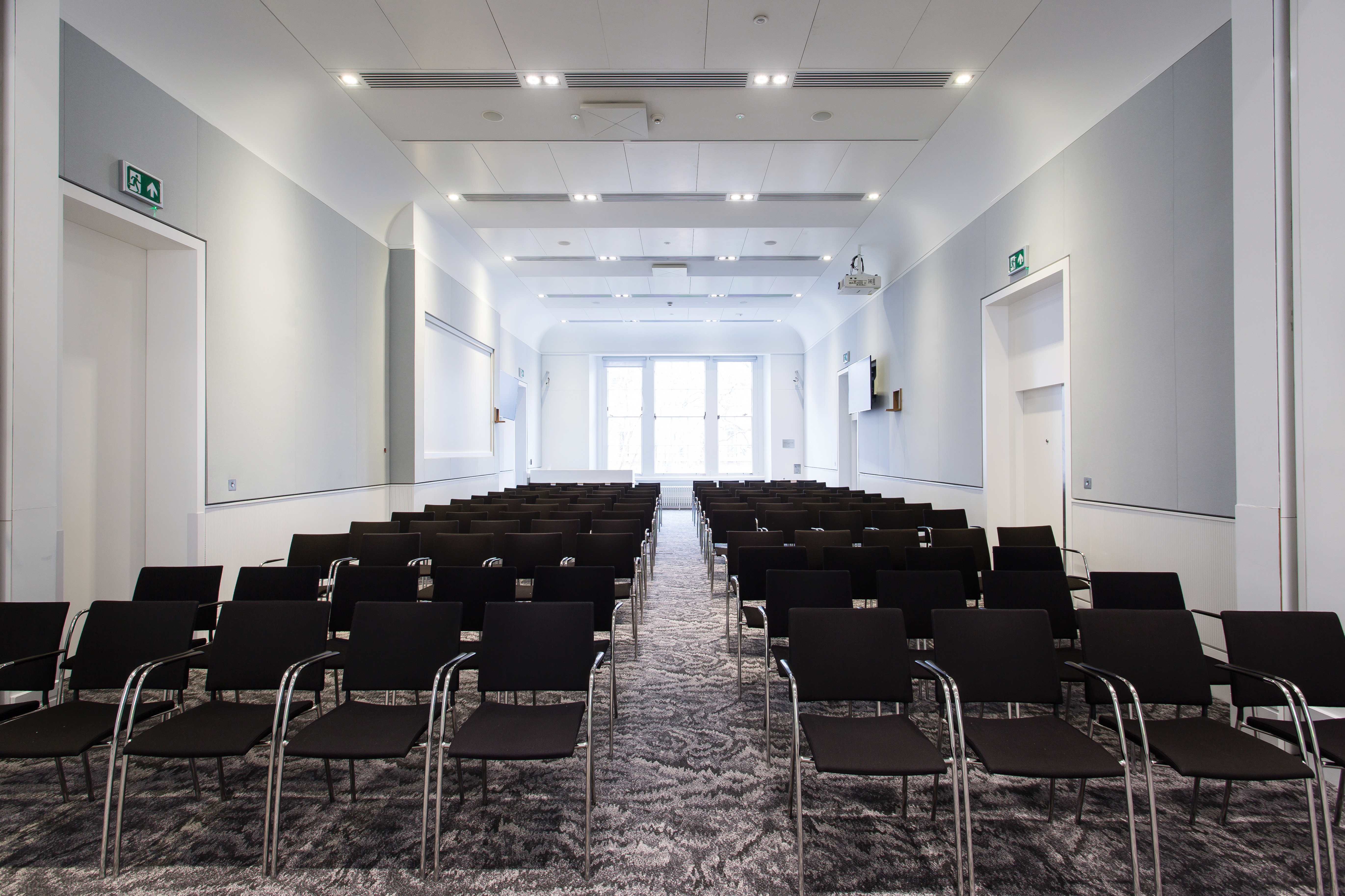 Al Qasimi meeting room with black chairs, ideal for presentations and workshops.