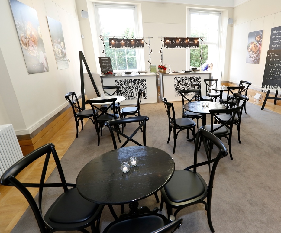 Stylish event space with black chairs, perfect for networking and casual gatherings.