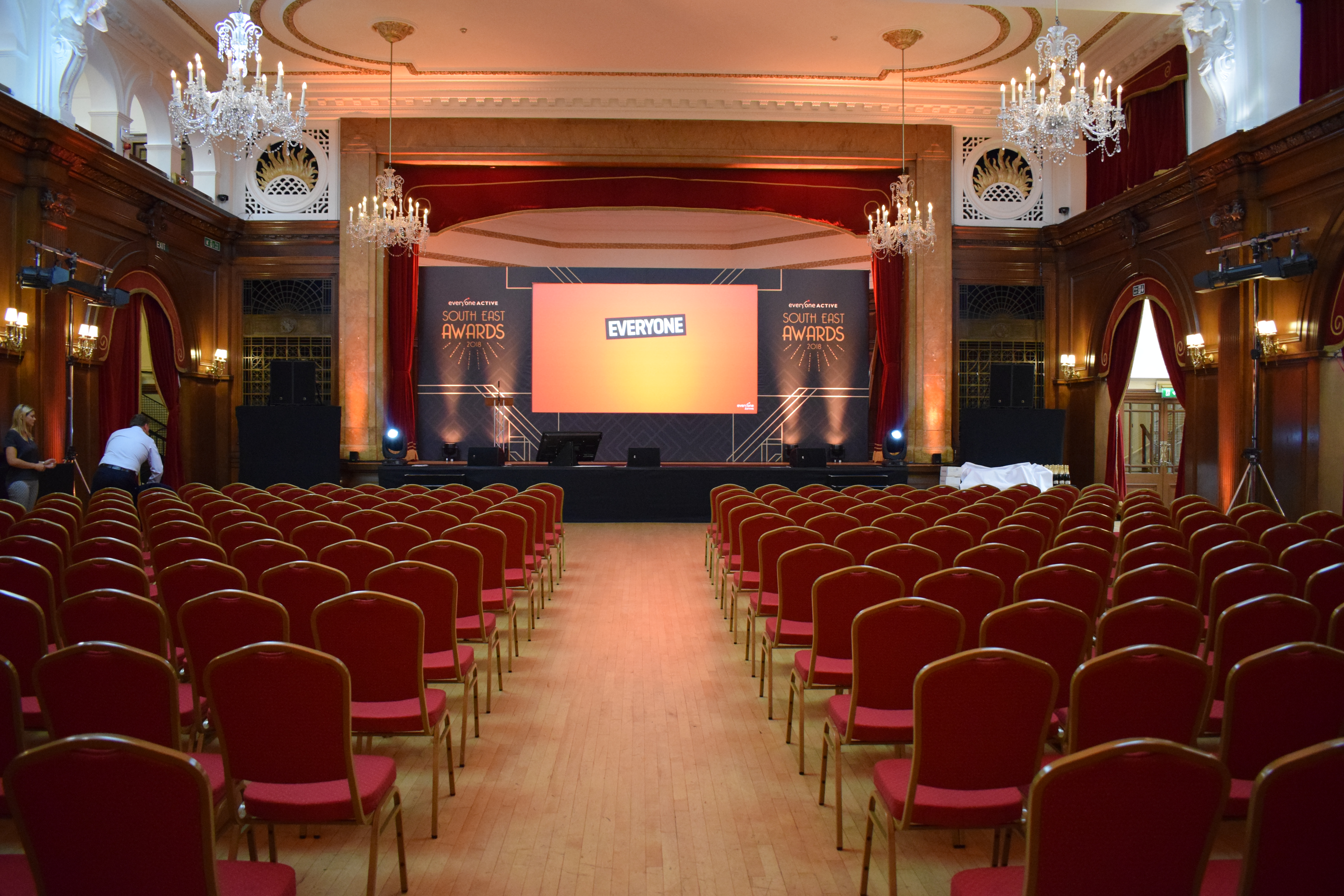 Porchester Hall Main Hall with red chairs for a formal awards ceremony event.