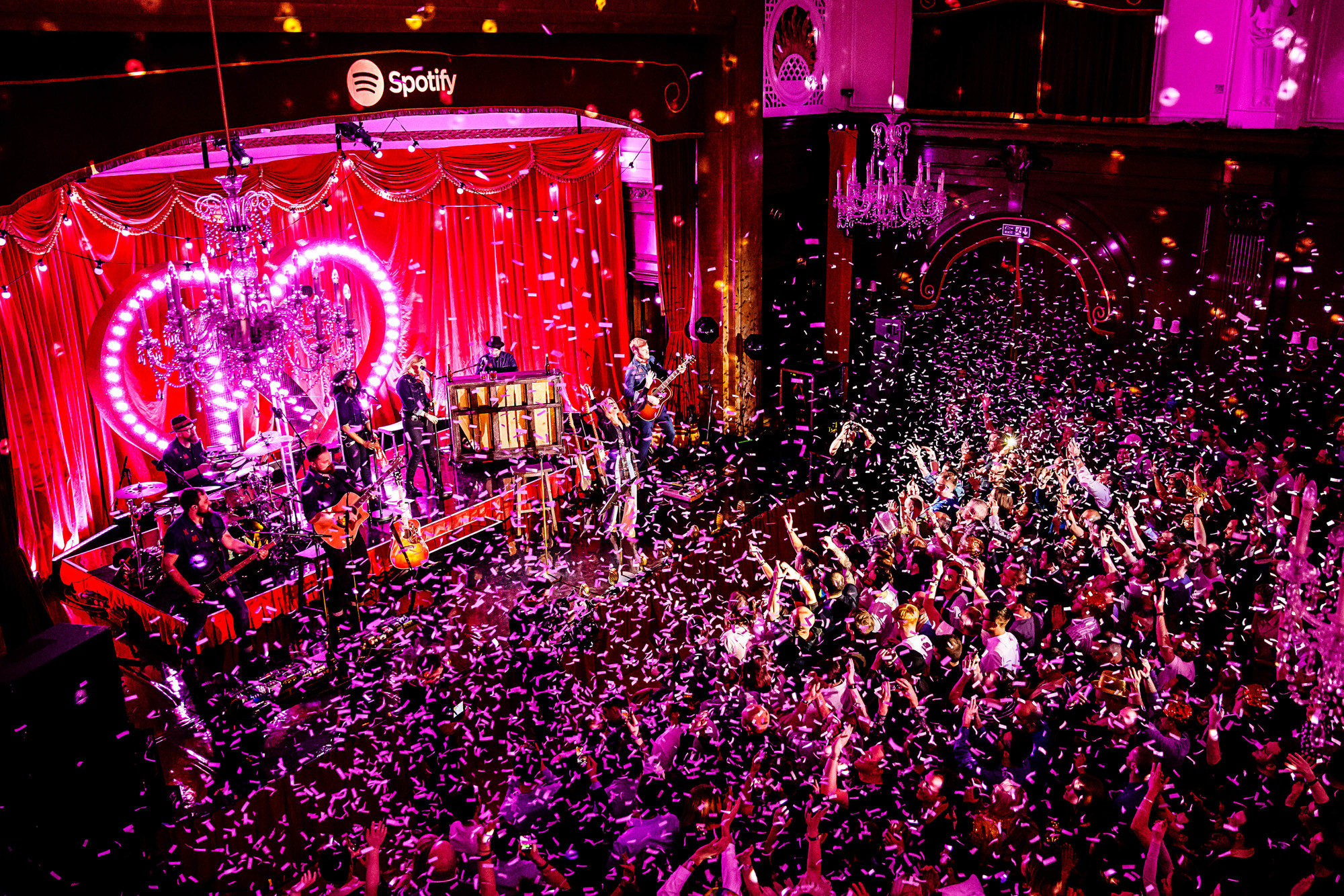 Porchester Hall Main Hall with live band, confetti, and vibrant corporate event atmosphere.