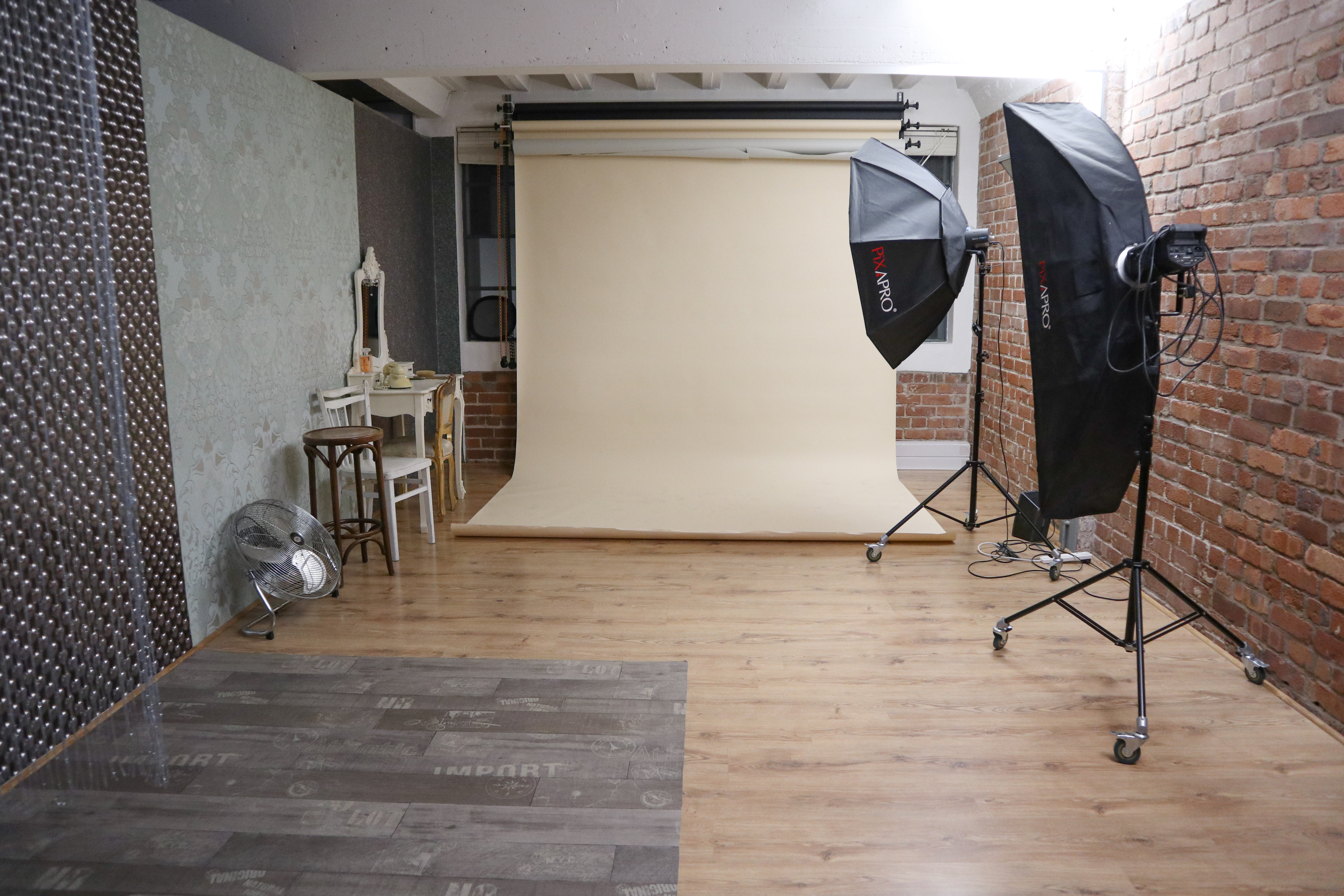 Versatile event space with rustic brick wall for workshops and gatherings at Xposure Studios.